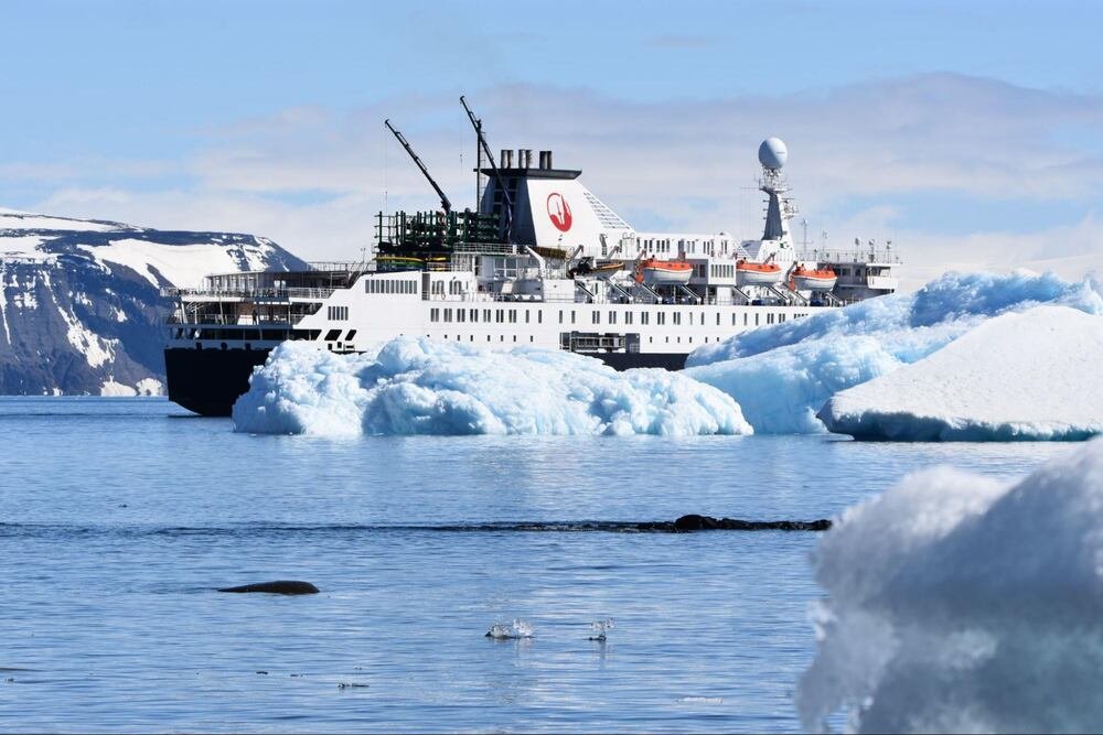 cruise ship in antarctica near ice bergs