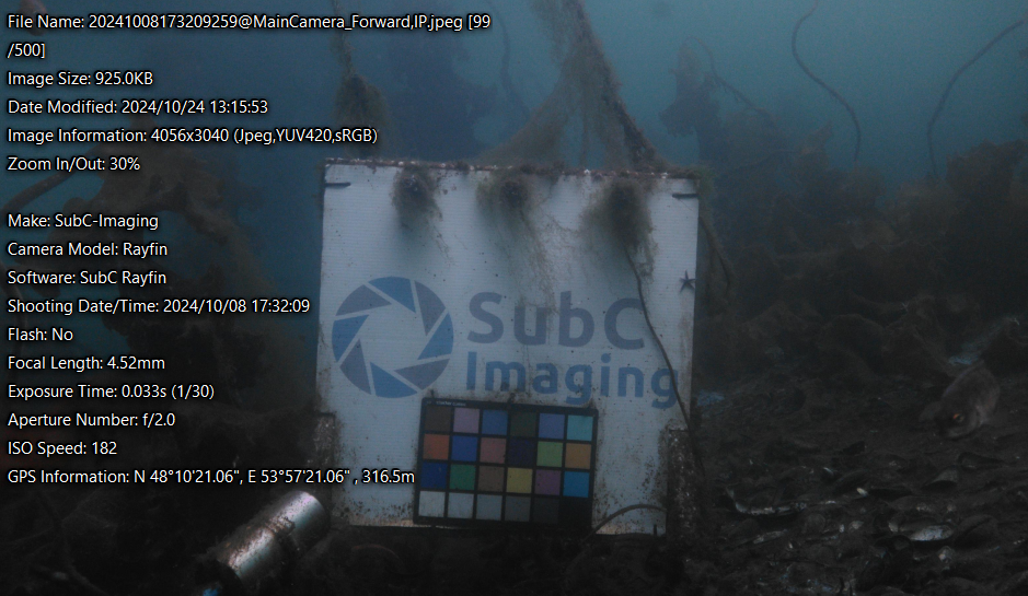 Underwater image captured by a SubC Rayfin camera showing calibration target and on-screen metadata including GPS coordinates, time, depth, and exposure details for data verification.