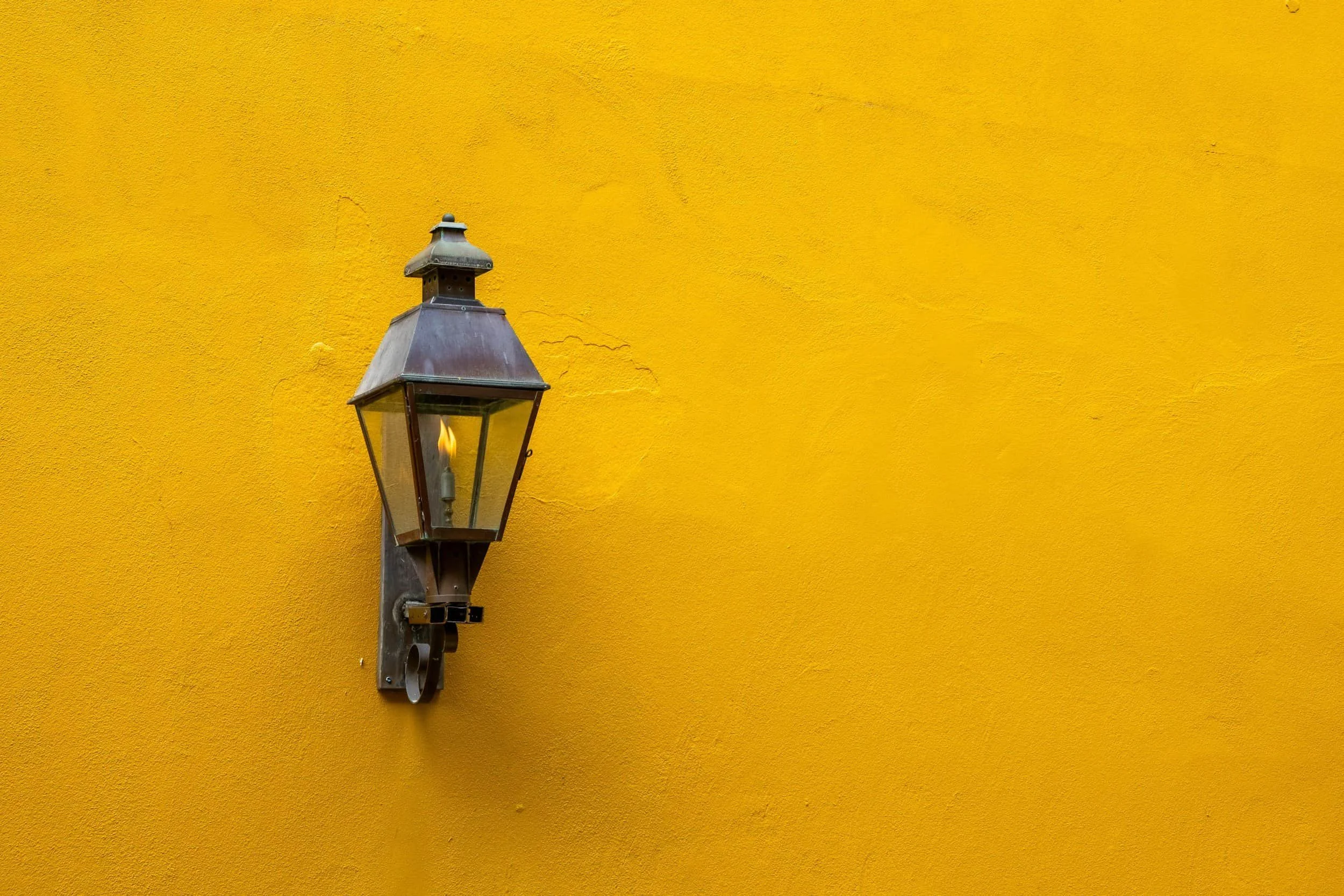 Yellow wall with gaslight lamp