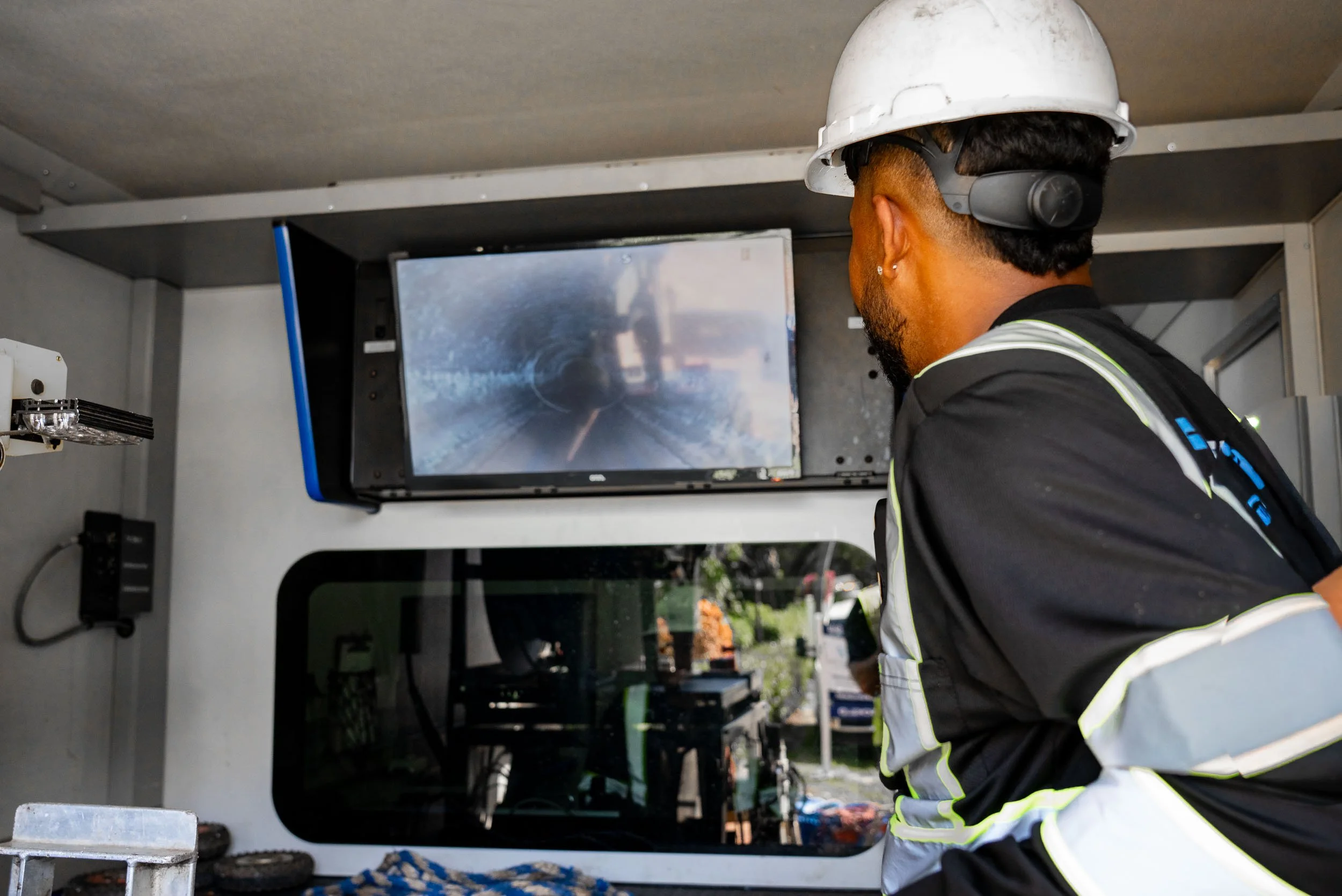 A high-pressure water jet cleaning the inside of a sewer or pipe.
