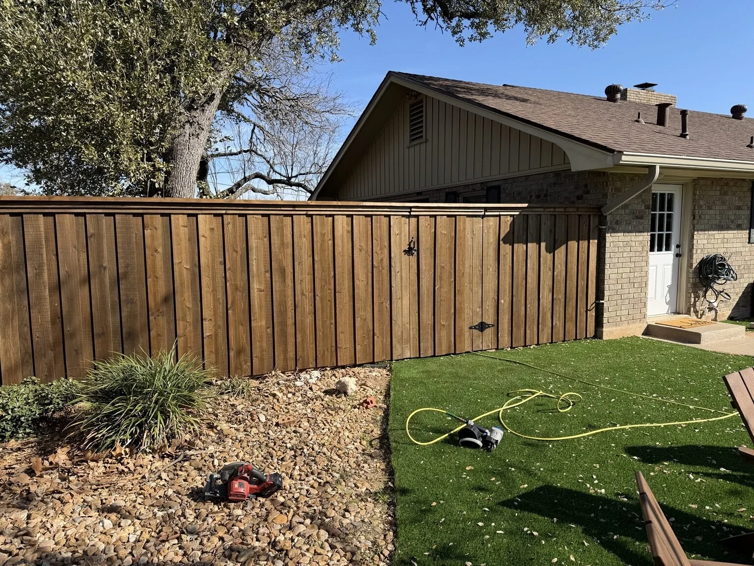 Pre-stained cedar automatic gates for an Airbnb in Fredericksburg, Texas