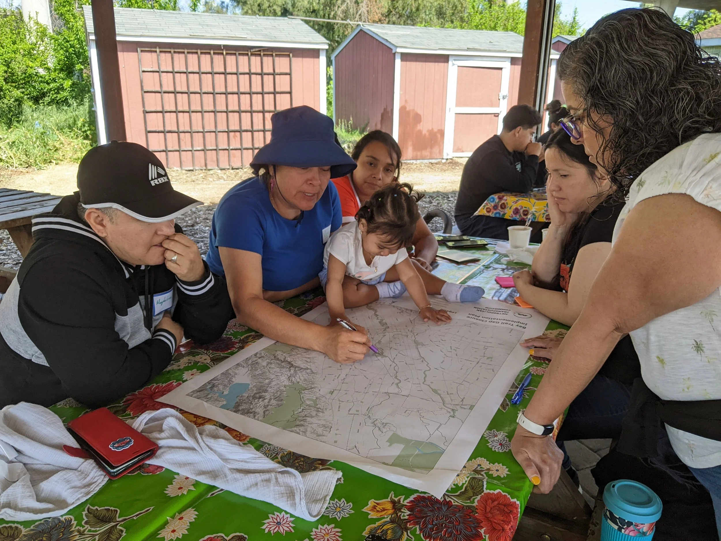 Group of people looking at a map during an outreach event.