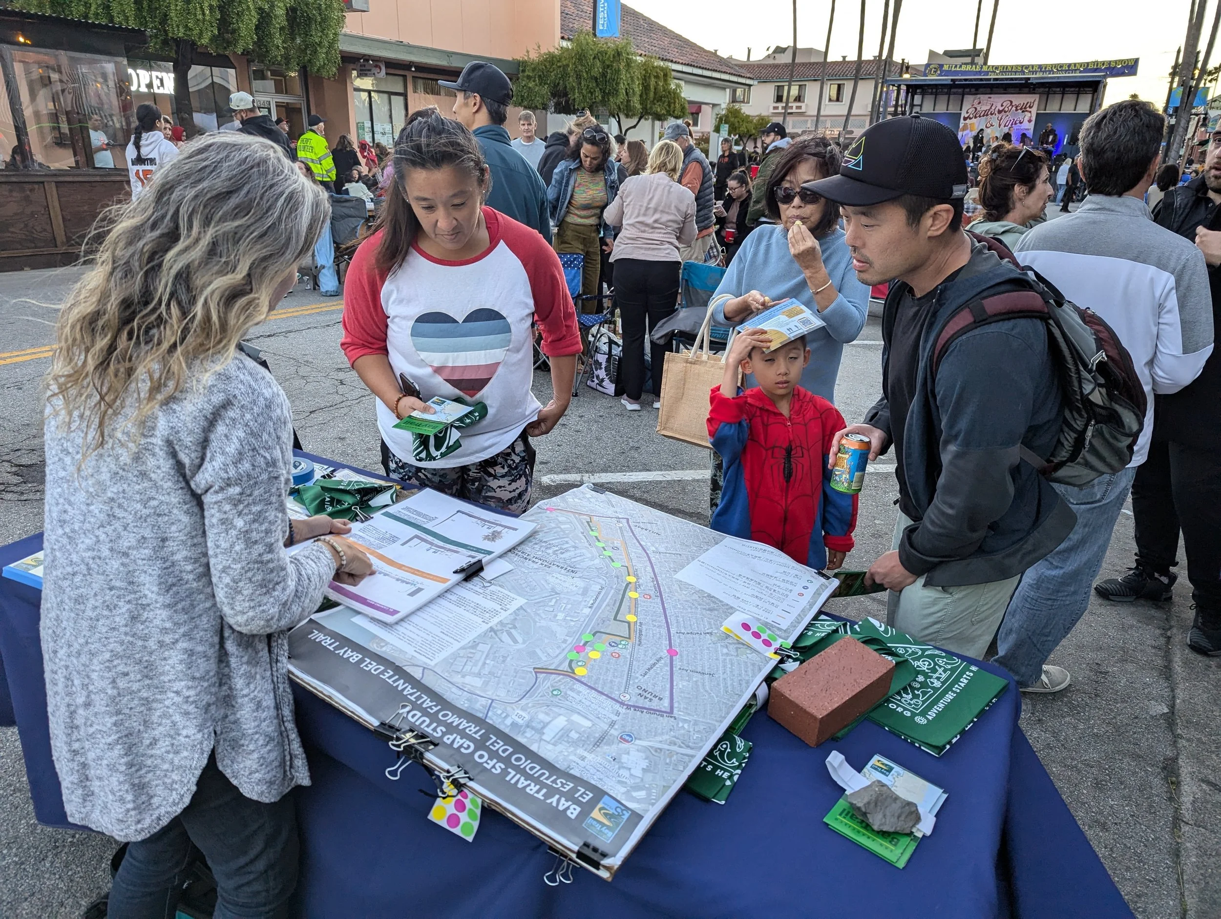 Large map with people around it during an outreach event.
