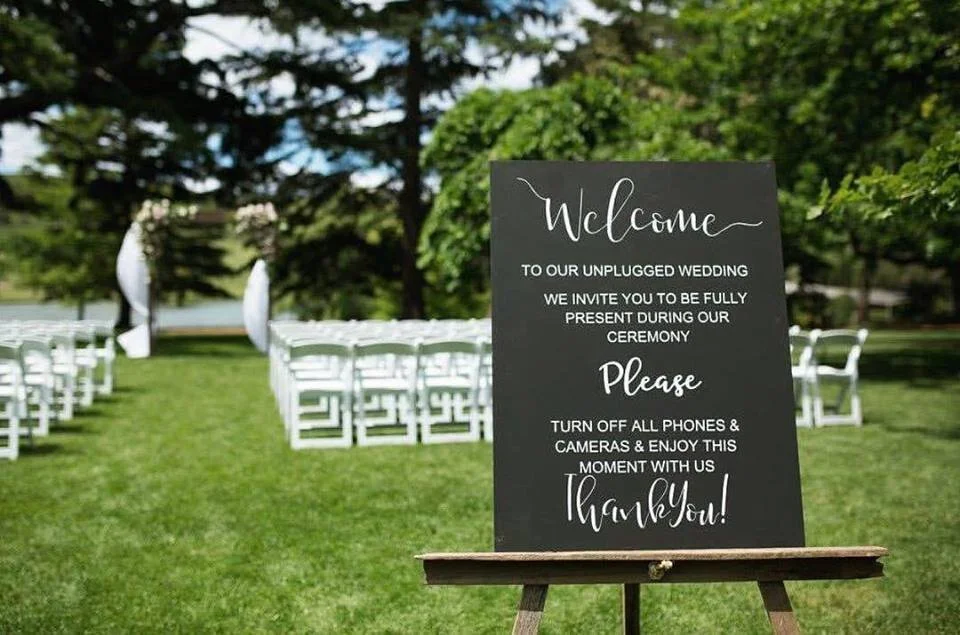 Unplugged wedding sign with black background and white text available for hire in Sydney and NSW, ideal for wedding ceremonies and reception styling.