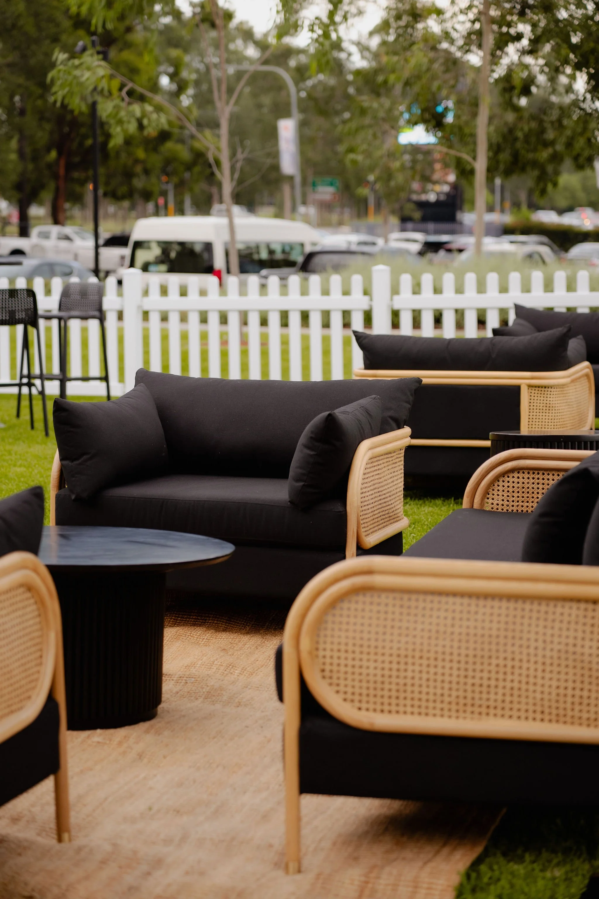 Natural Rattan lounge with all black cushioning in a office building