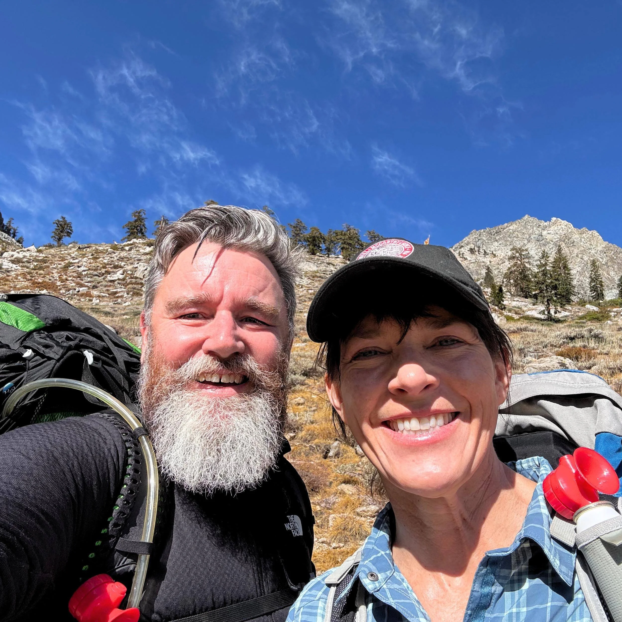 Justin and Jennifer Camp backpacking over the Kearsarge Pass