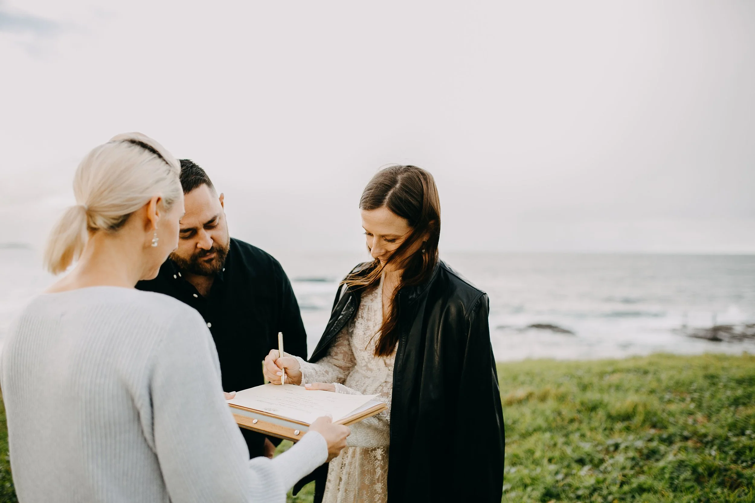 Jacqua Celebrant with a couple for their legals only ceremony, signing the marriage paperwork