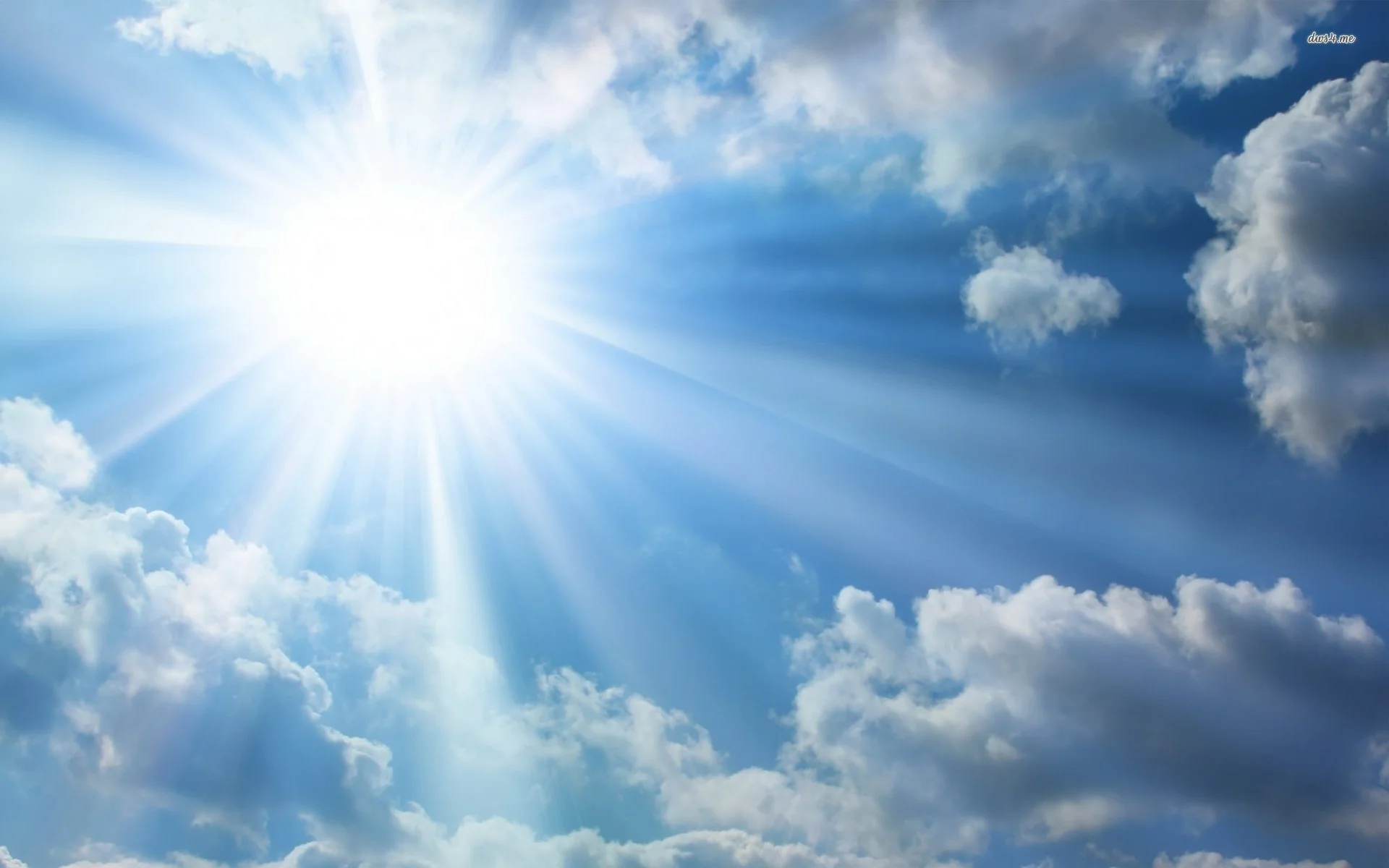 the sun in a blue sky with clouds