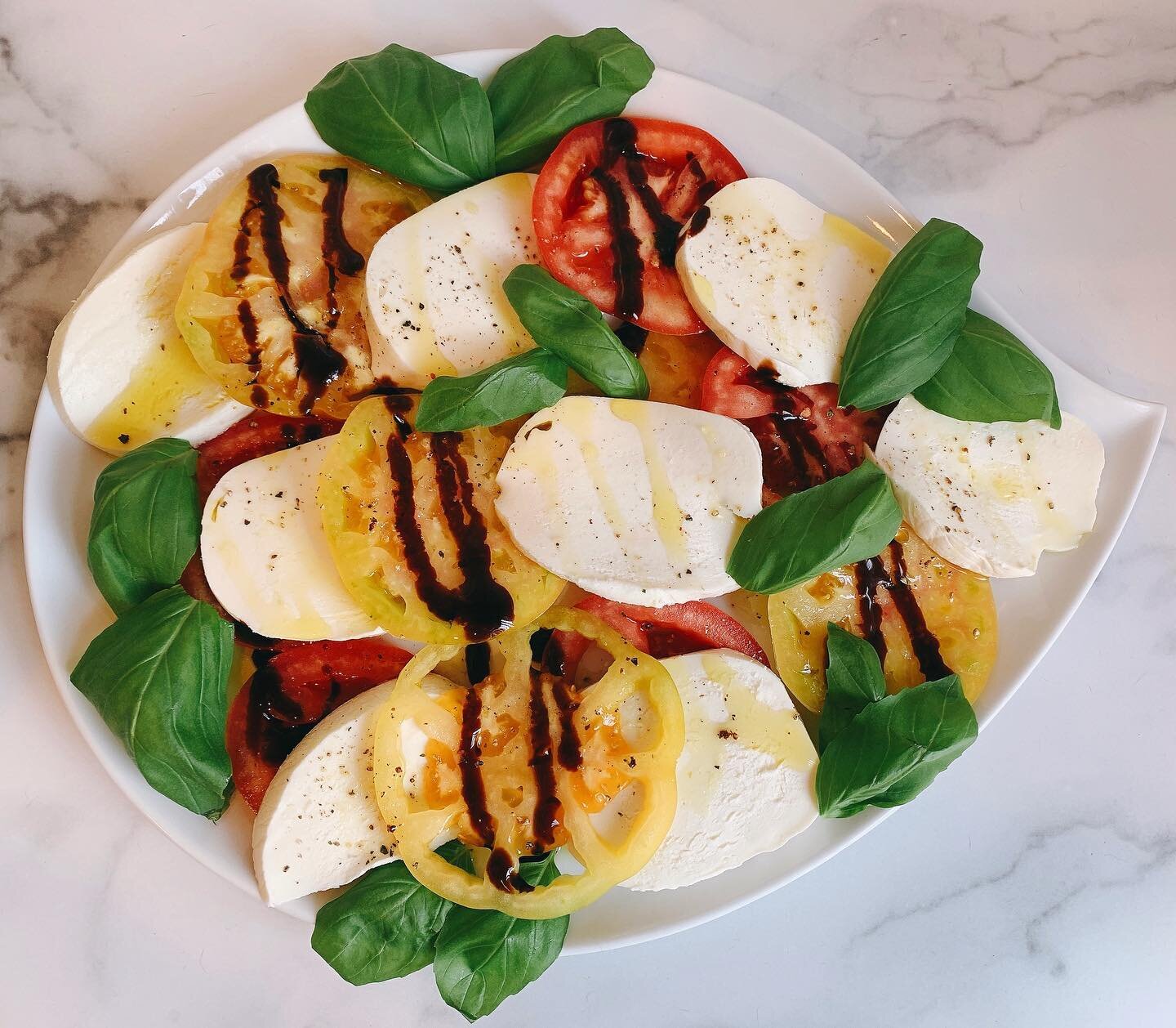 Summer isn&rsquo;t over yet!  Heirloom tomato caprese salad 🍅 with perfect @gothamgreens basil 🍃 and @lionilatticini fresh mozzarella 👌🏻