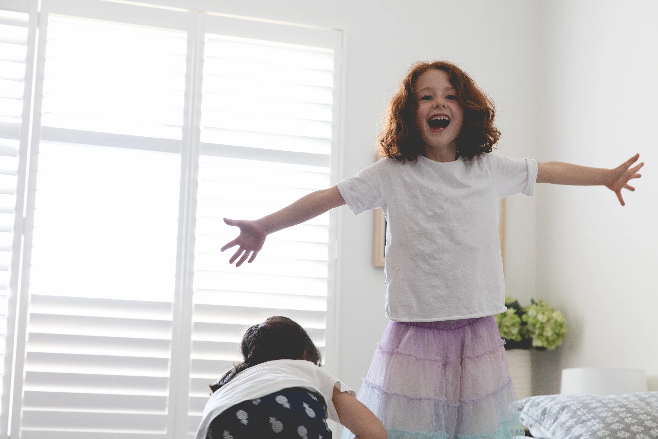 young girl on top of a bed