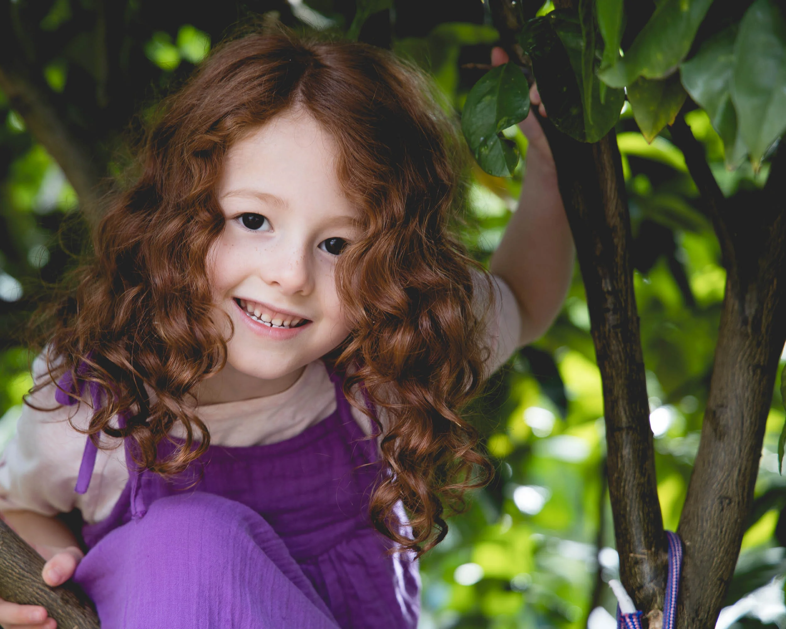 young girl in tree