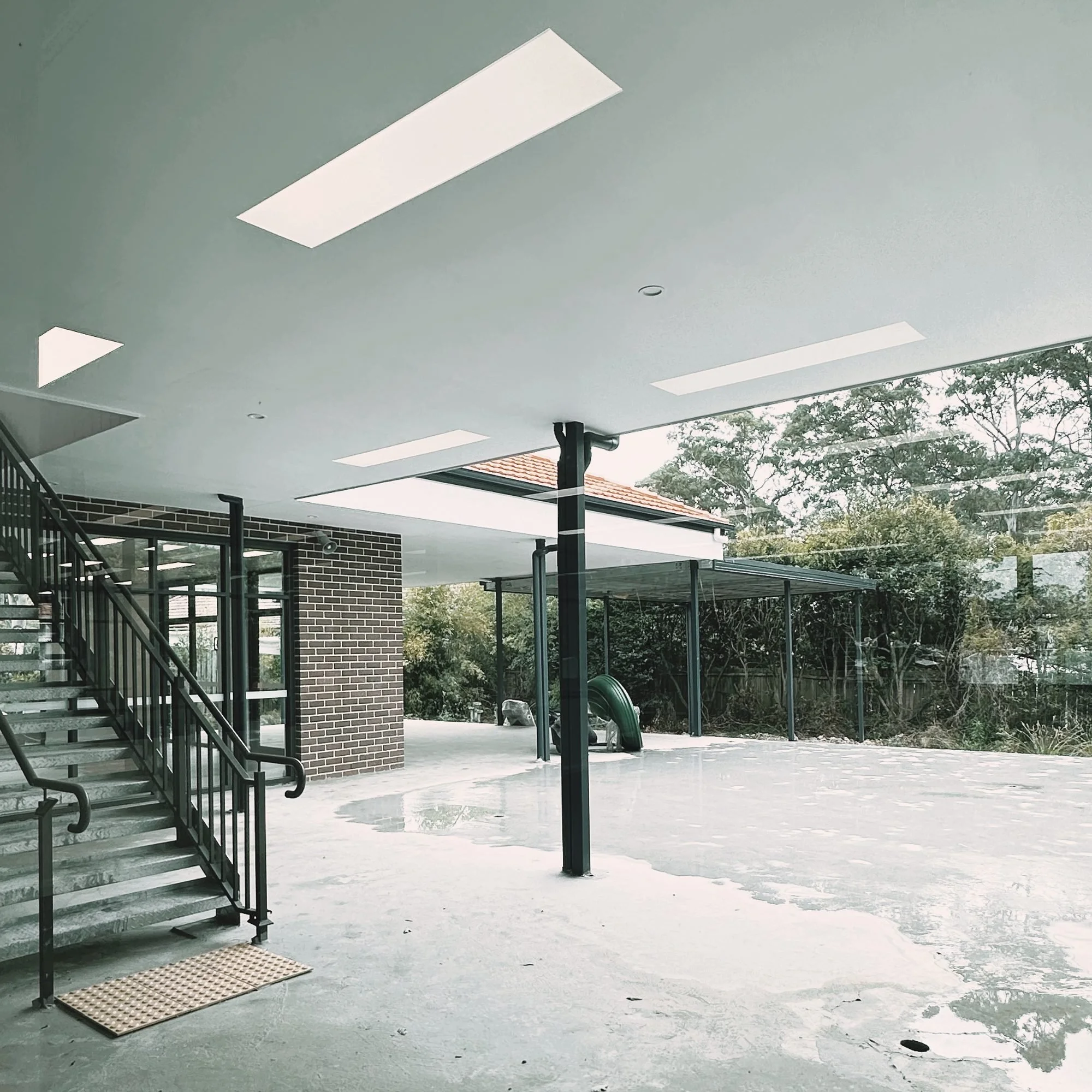 Wahroonga Childcare Centre, Sydney – covered play area with skylights and stair – Archian Architects