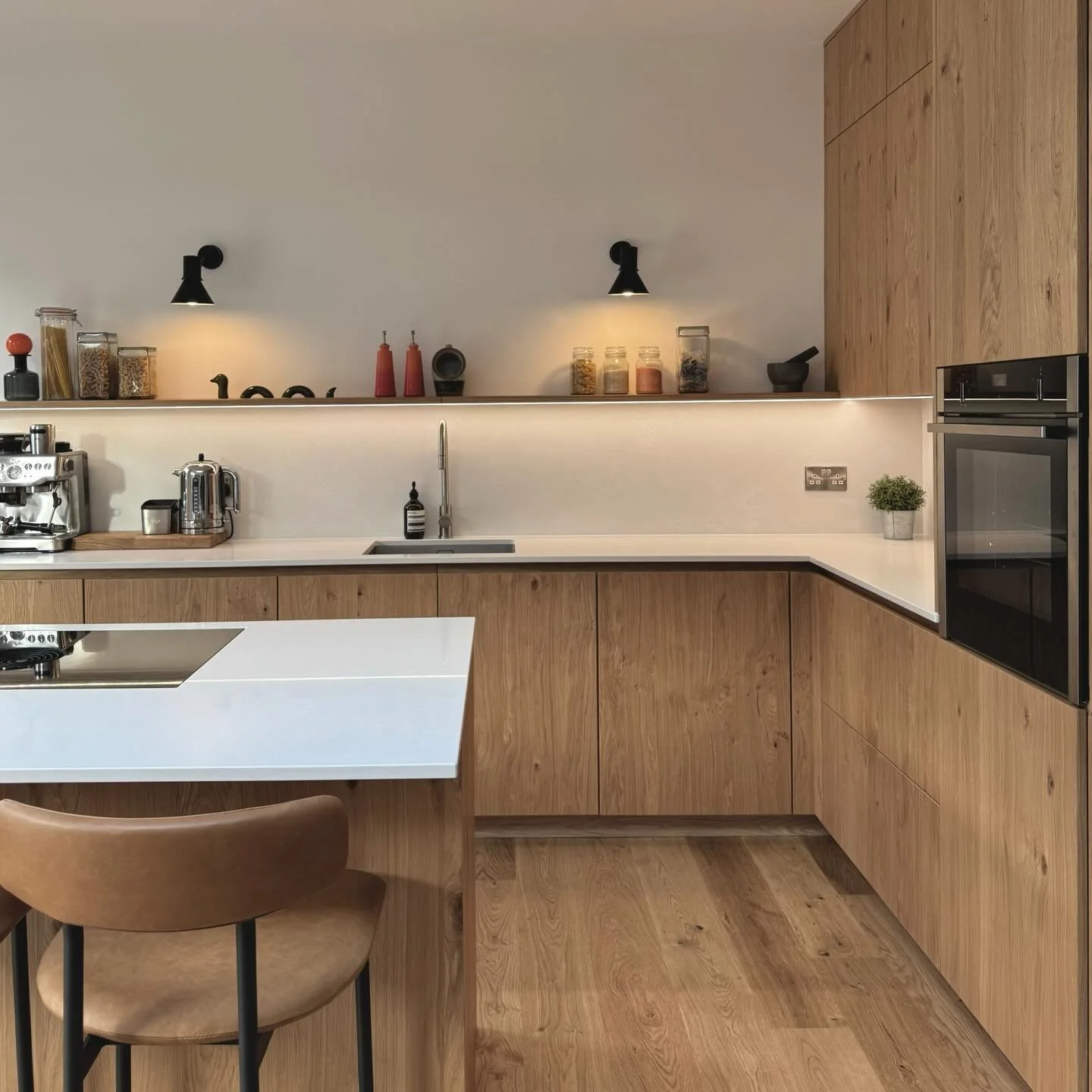A refined, Scandi-inspired kitchen where clean lines meet warm oak detailing. 

A generous island anchors the space, designed for effortless entertaining and lazy Sunday brunches. 

Cabinetry: Oak veneered slab doors with oak handle detail
Work surfa