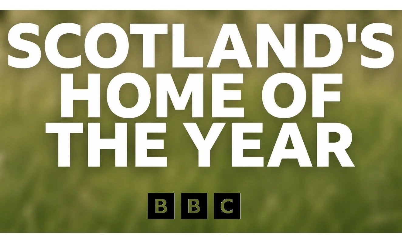 Text reading 'Scotland's Home of the Year' with BBC logo at bottom, over a blurred green grassy background.