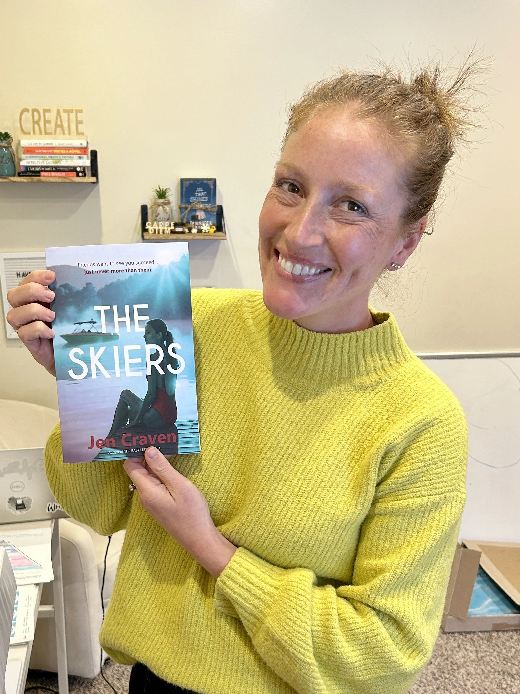 Author Jen Craven holding a copy of her book, The Skiers.