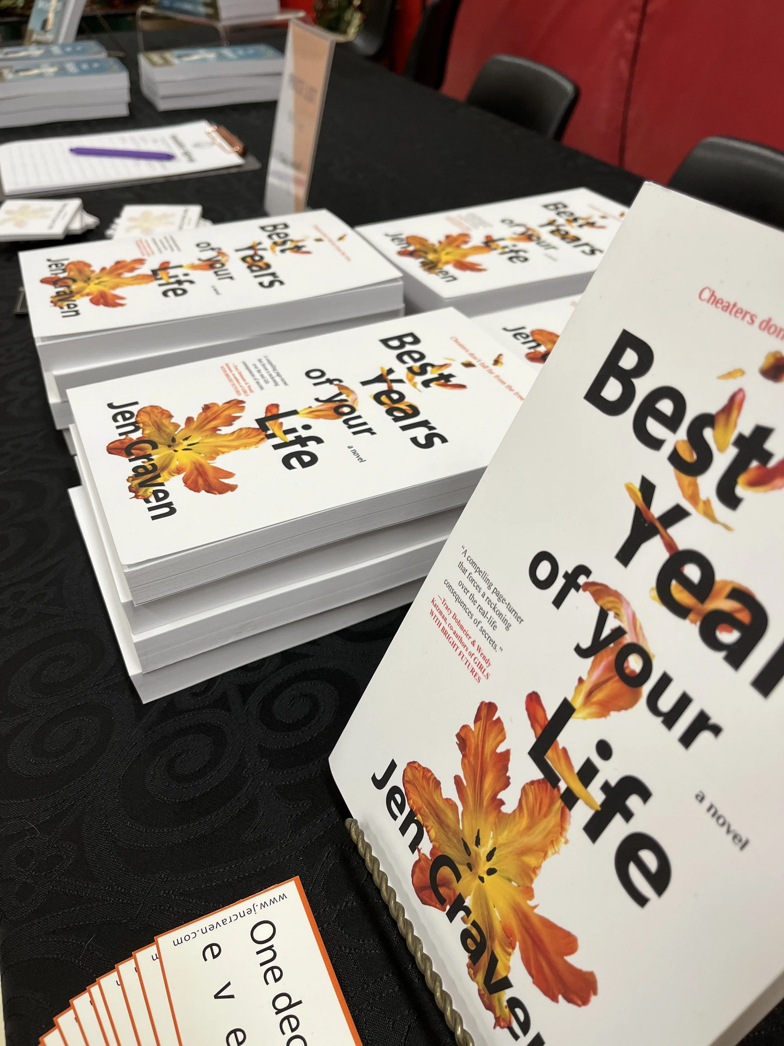 Copies of Jen Craven's novel, Best Years of Your Life, on a table at a book signing.