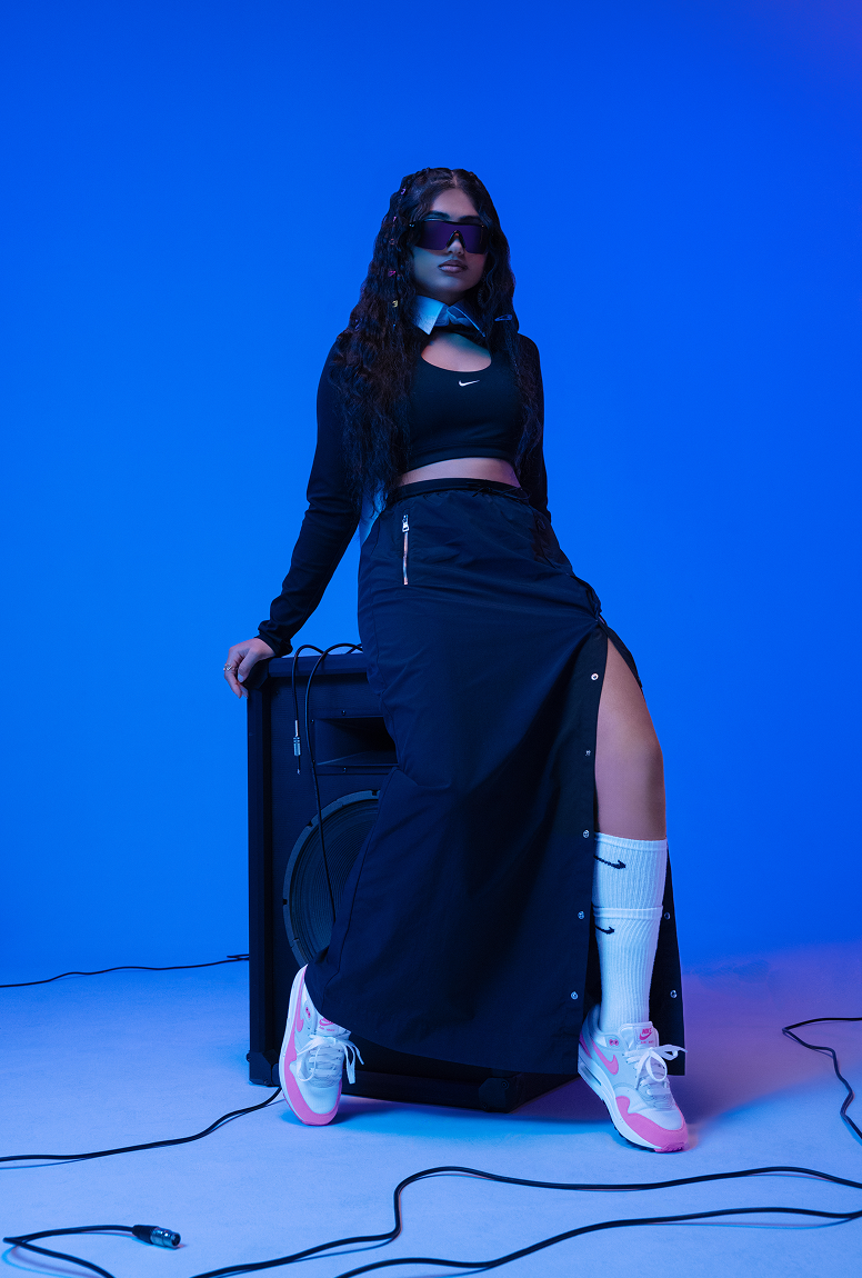 Ashley Mehta sitting on speaker