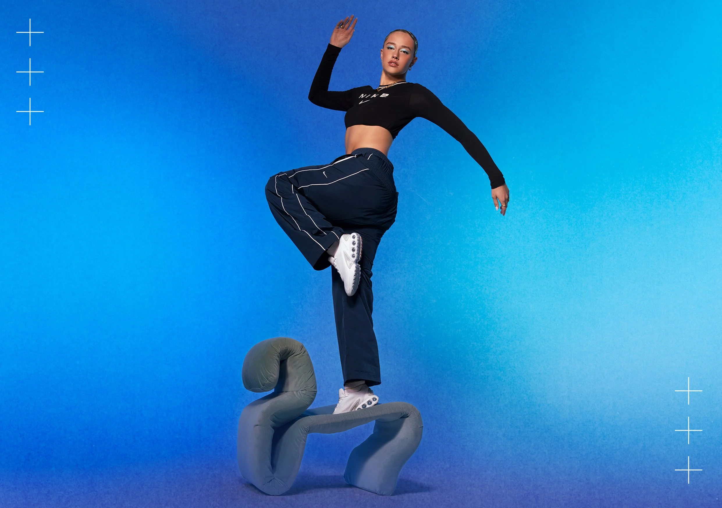 Mia standing on chair with a blue gradient background
