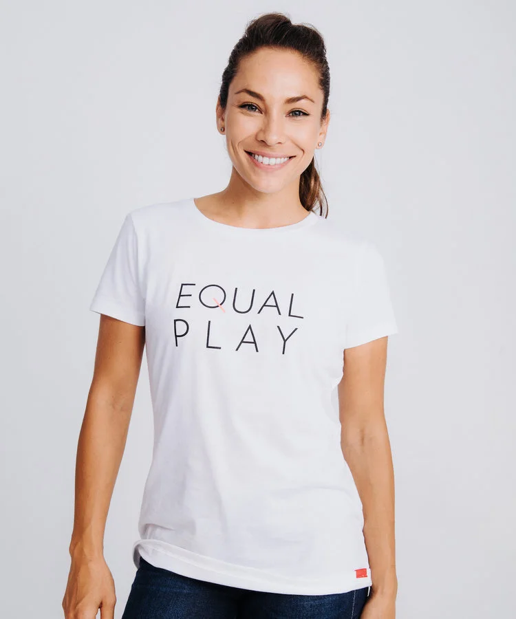 Woman standing in front of white background wearing an Equal pay shirt