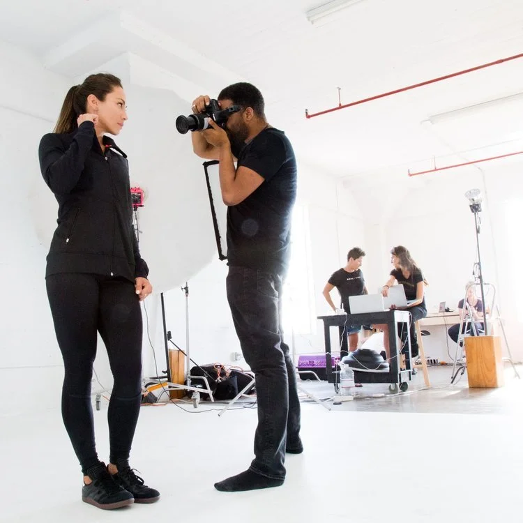Behind the scenes of model and photographer in a studio