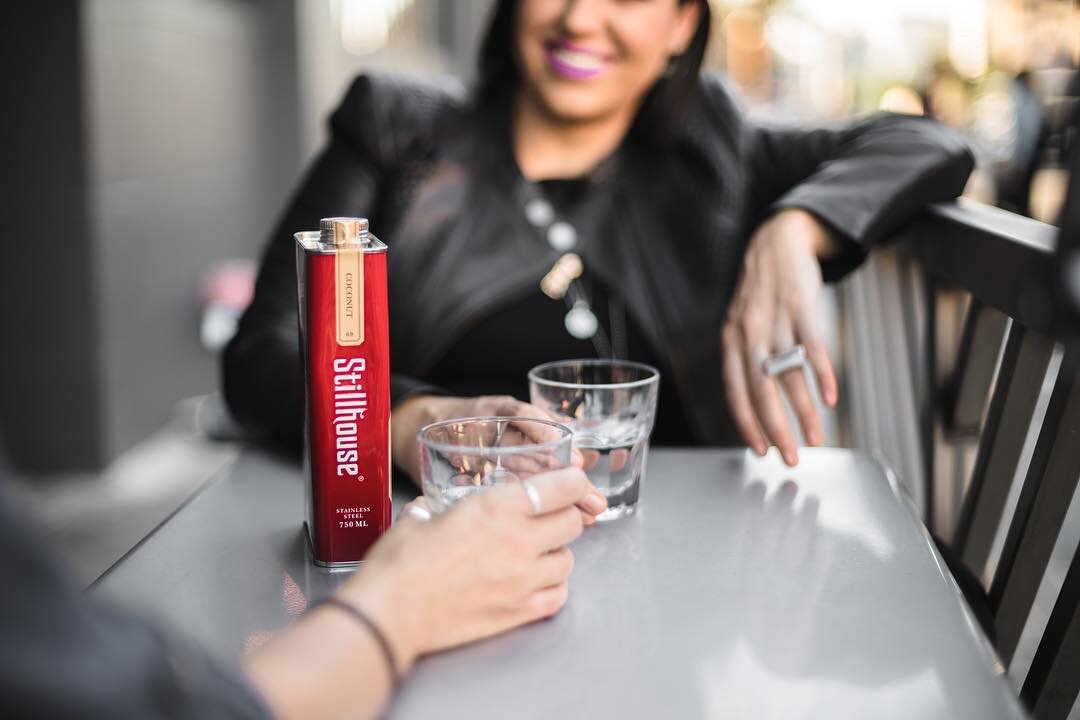 Two people drinking Stillhouse at a table