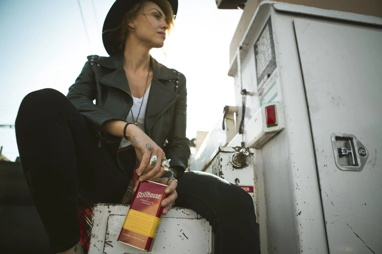 Woman holding a Stillhouse can