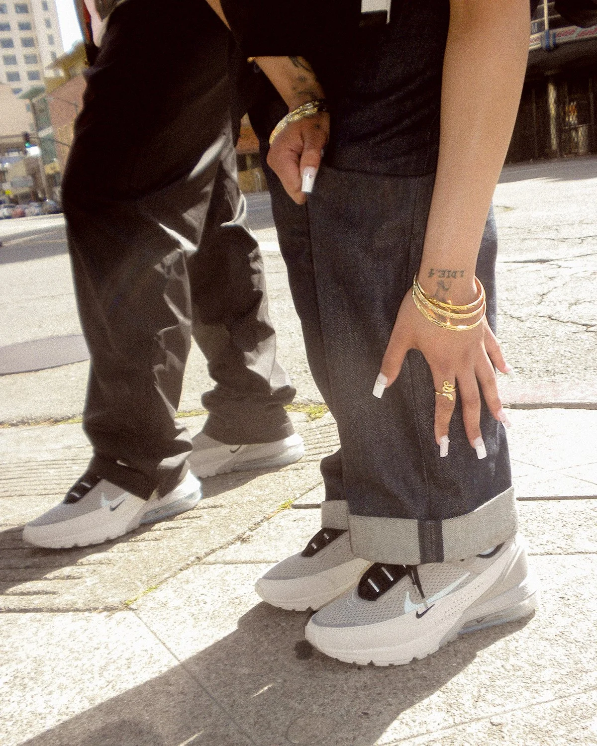 Women wearing Nike Air Max on sidewalk