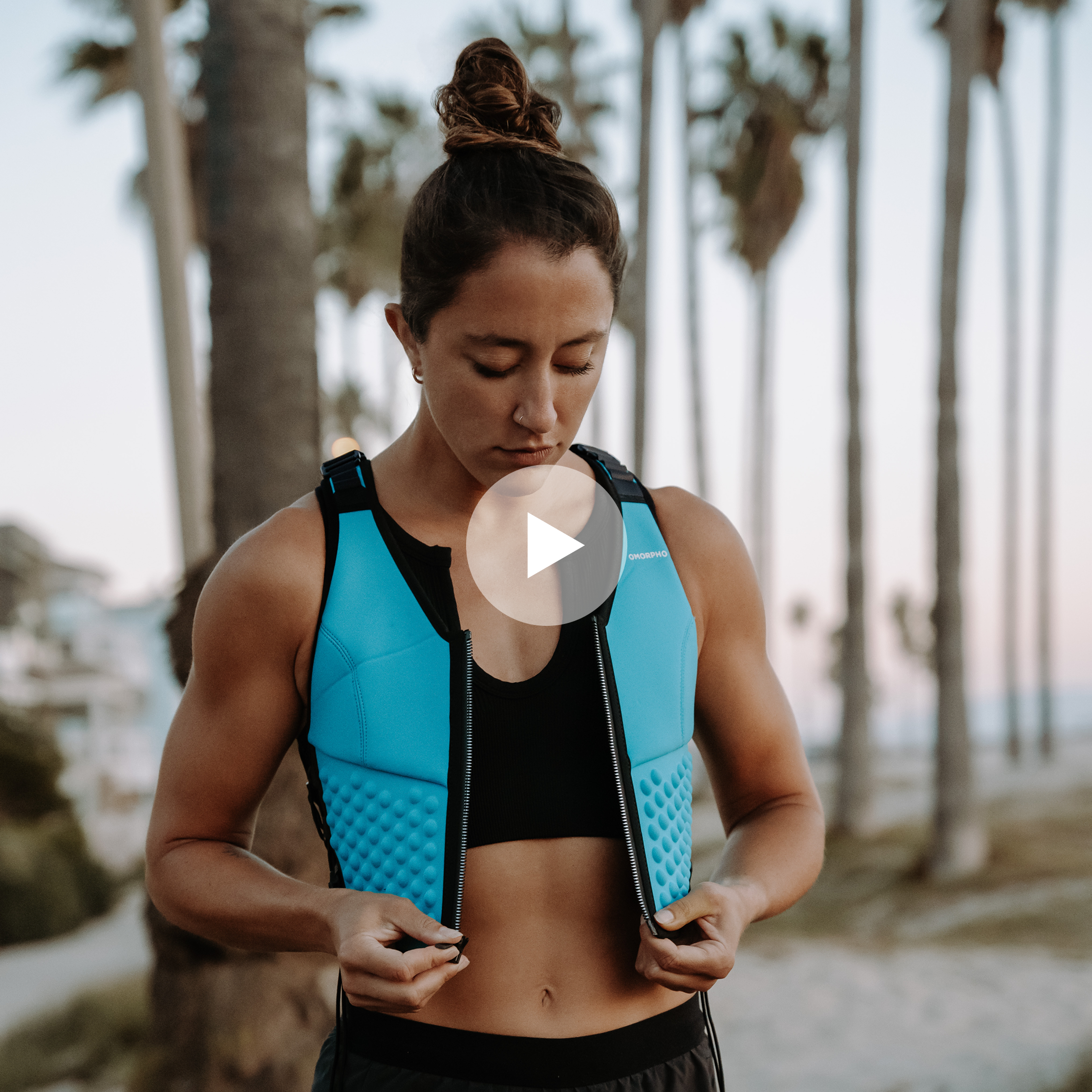 Girl on the beach wearing Omorpho Weighted G-Vest+