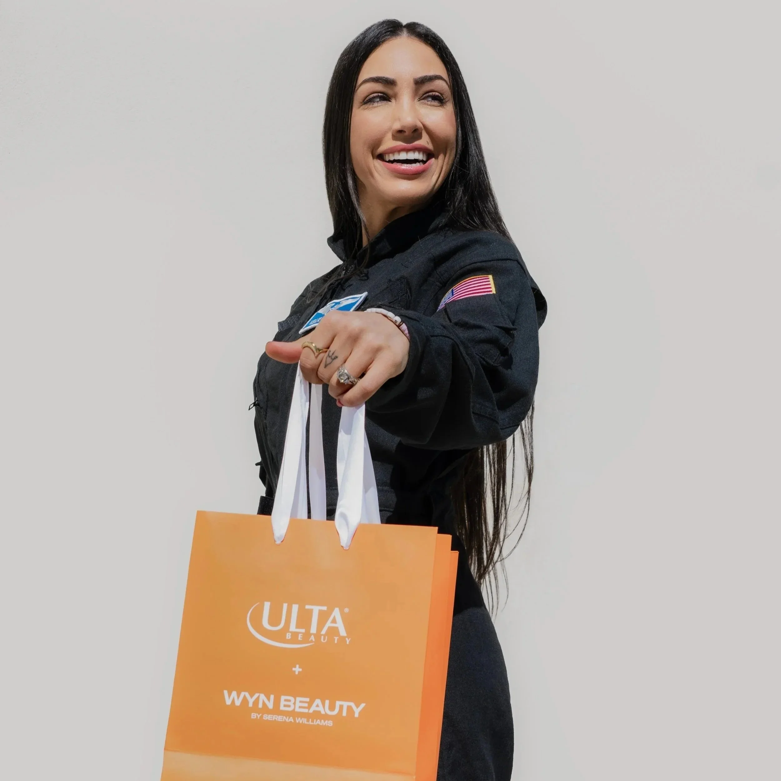 Kellie Gerardi with orange Ulta Beauty bag