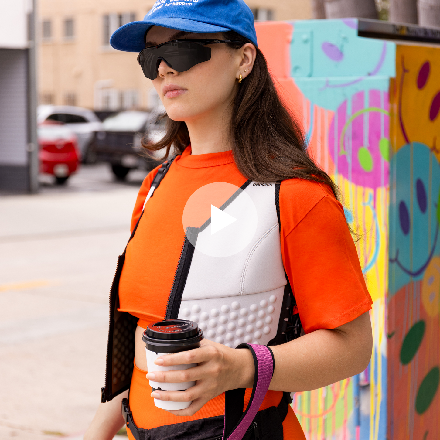 Kady Lone in Omorpho Weighted G-Vest on a walk while holding a coffee