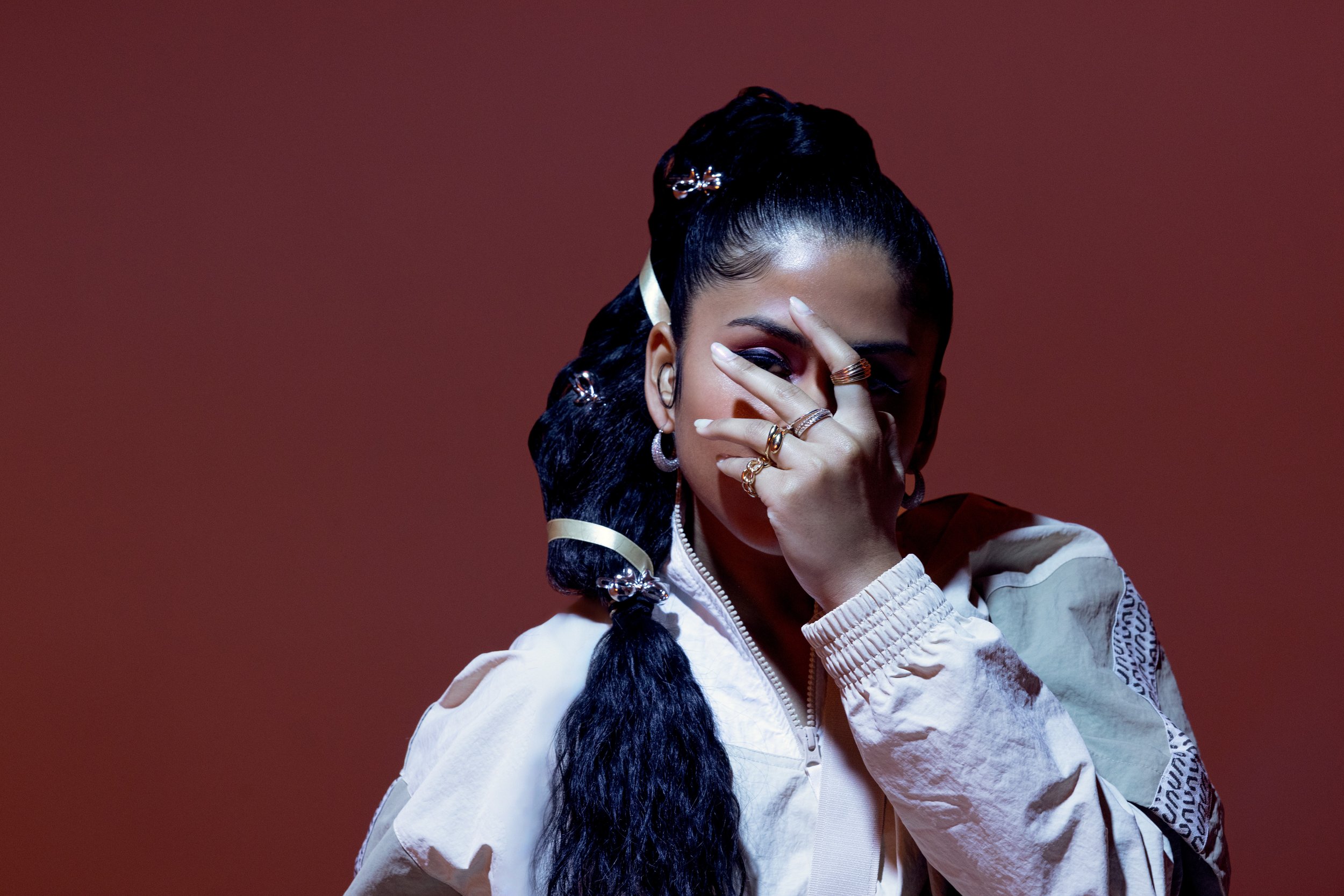 Ashley Mehta with hand in front of her face