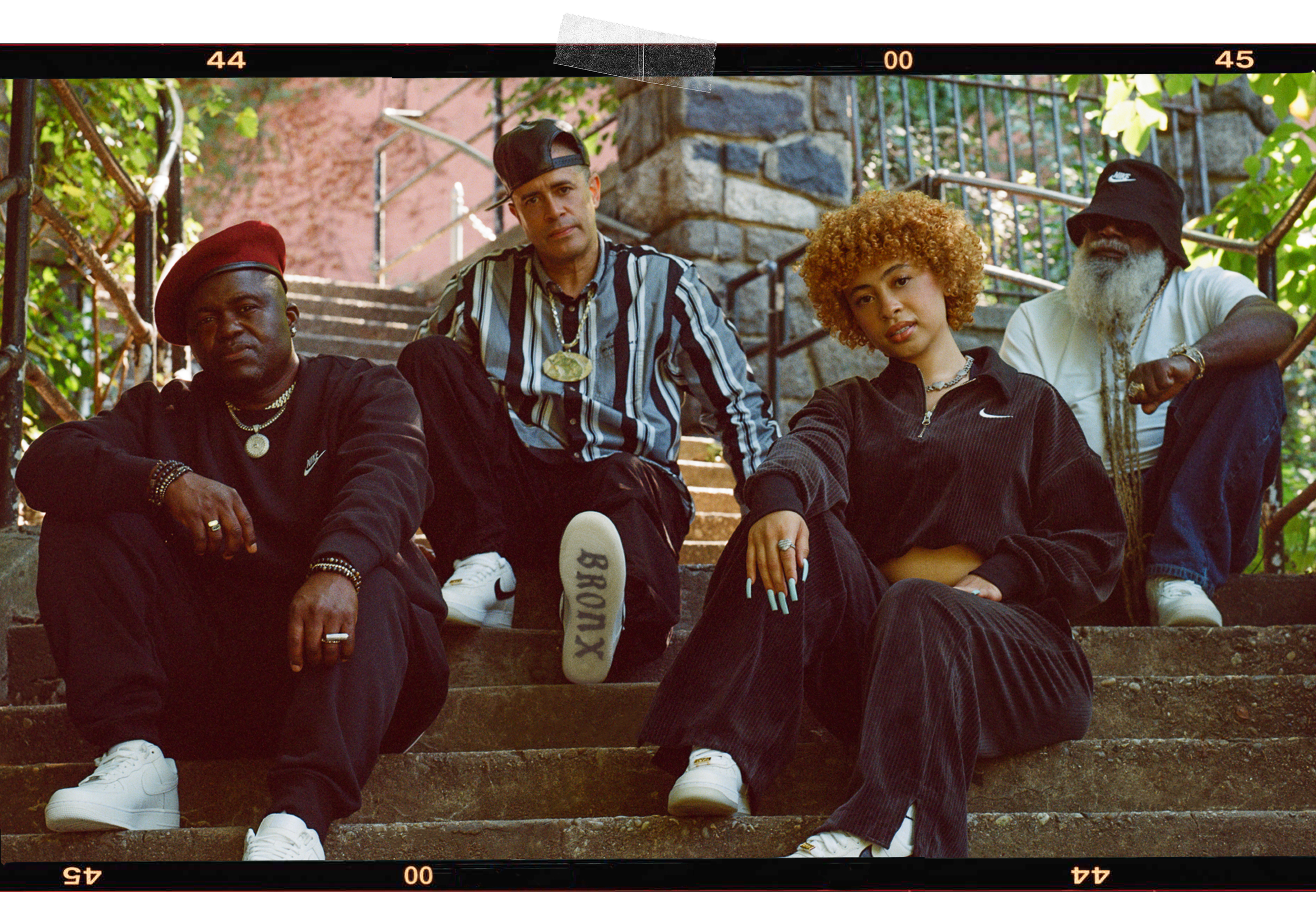 four people sitting outside on steps