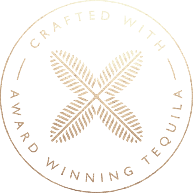 Palm leaves in shape of an "x" in a circle with the words "created with award winning tequila"