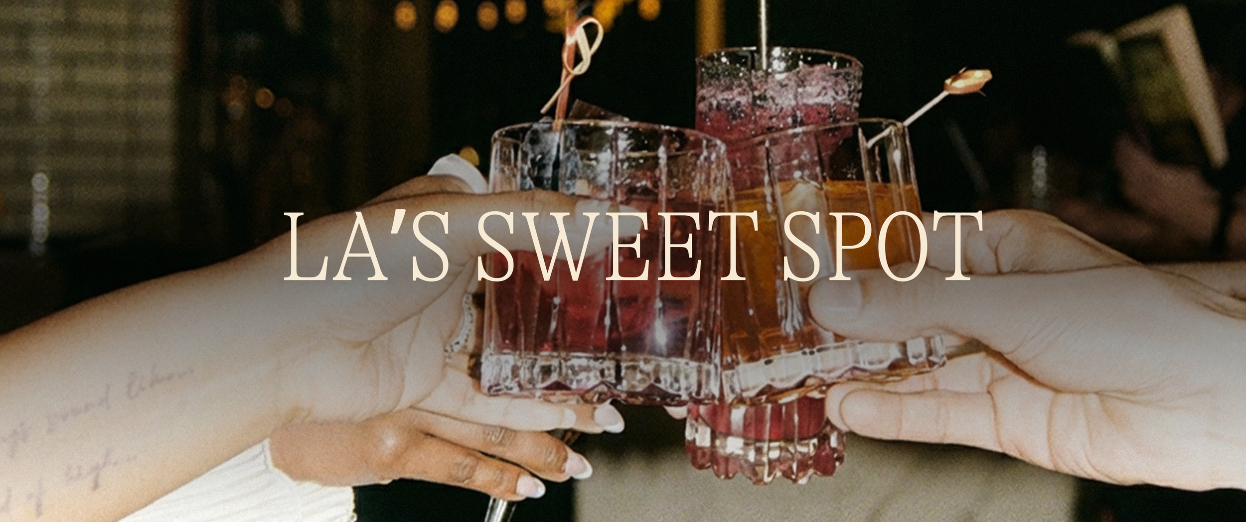 White text in all caps "La's Sweet Spot" over top an image of people cheering with their drinks