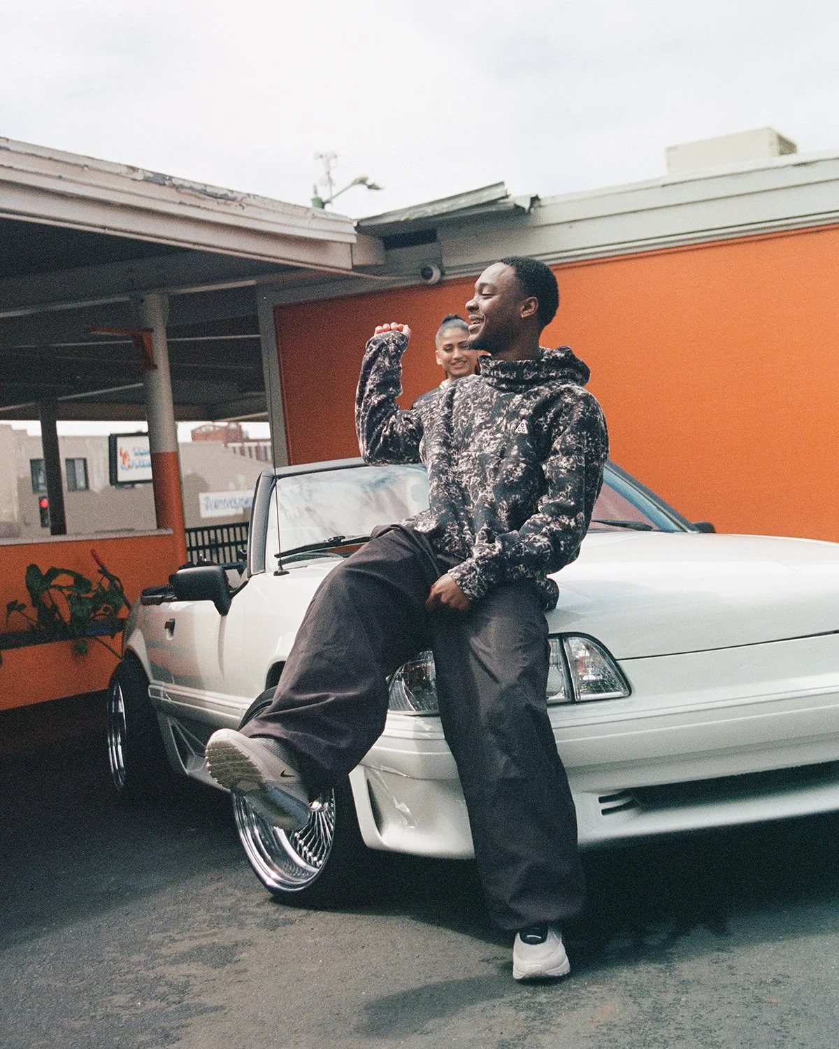Man sitting on car wearing Nike Air Max