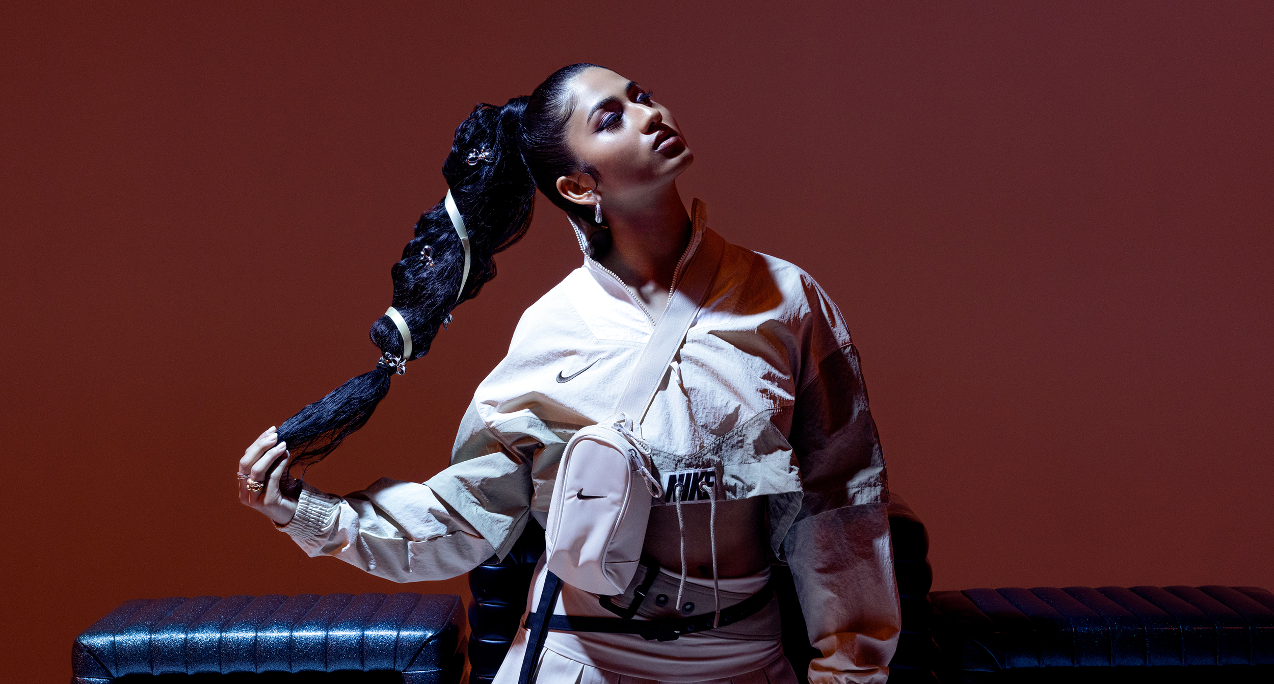 Ashley Mehta in front of maroon background
