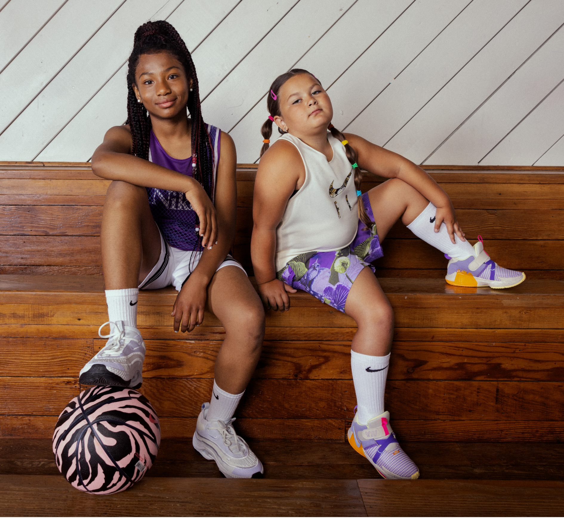 Riley and Tiara on basketball bleachers