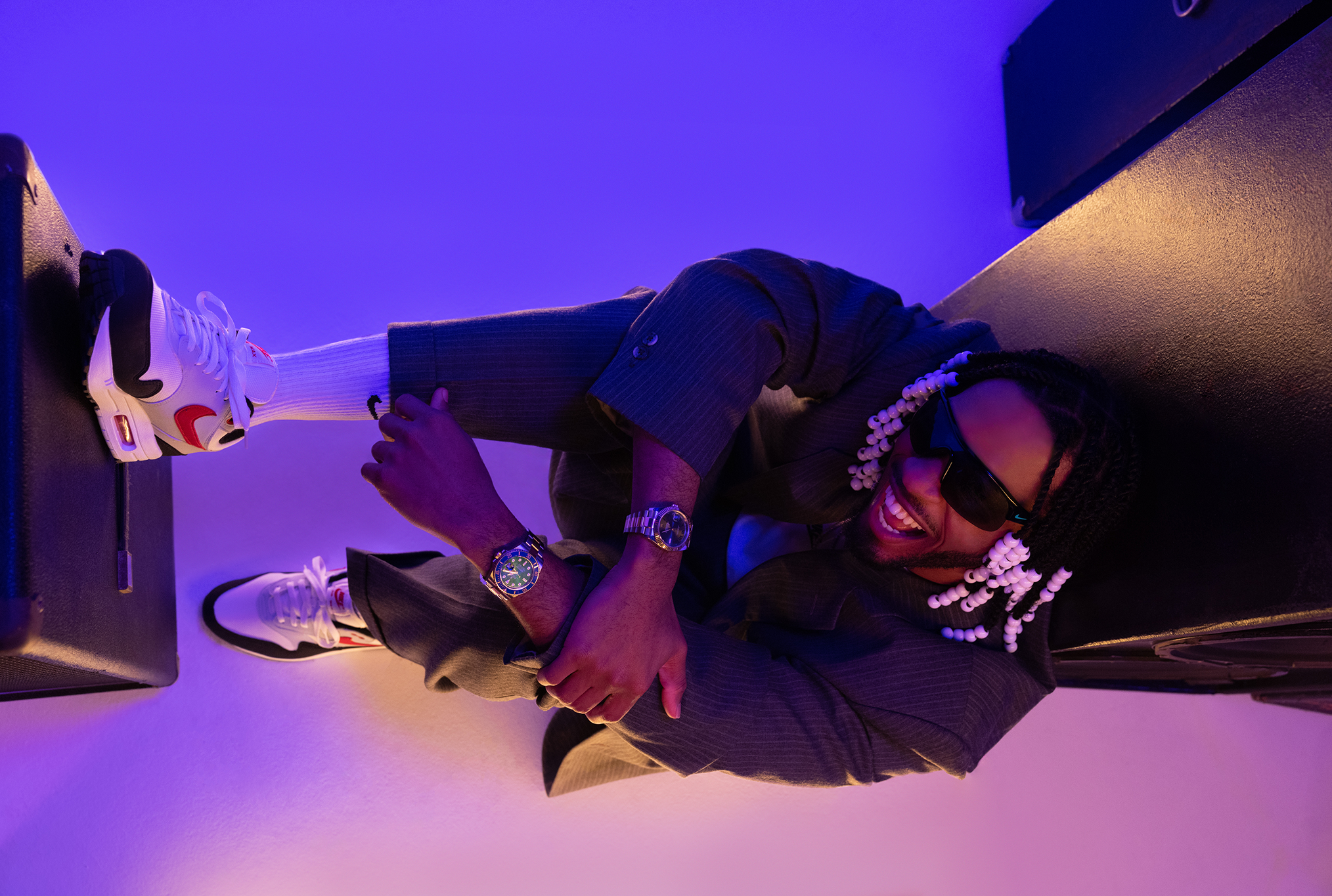 Armani leaning on speaker