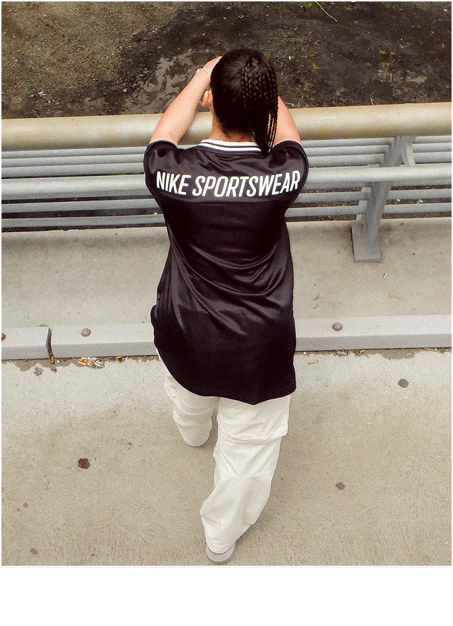 Girl wearing Nike Sportswear black shirt