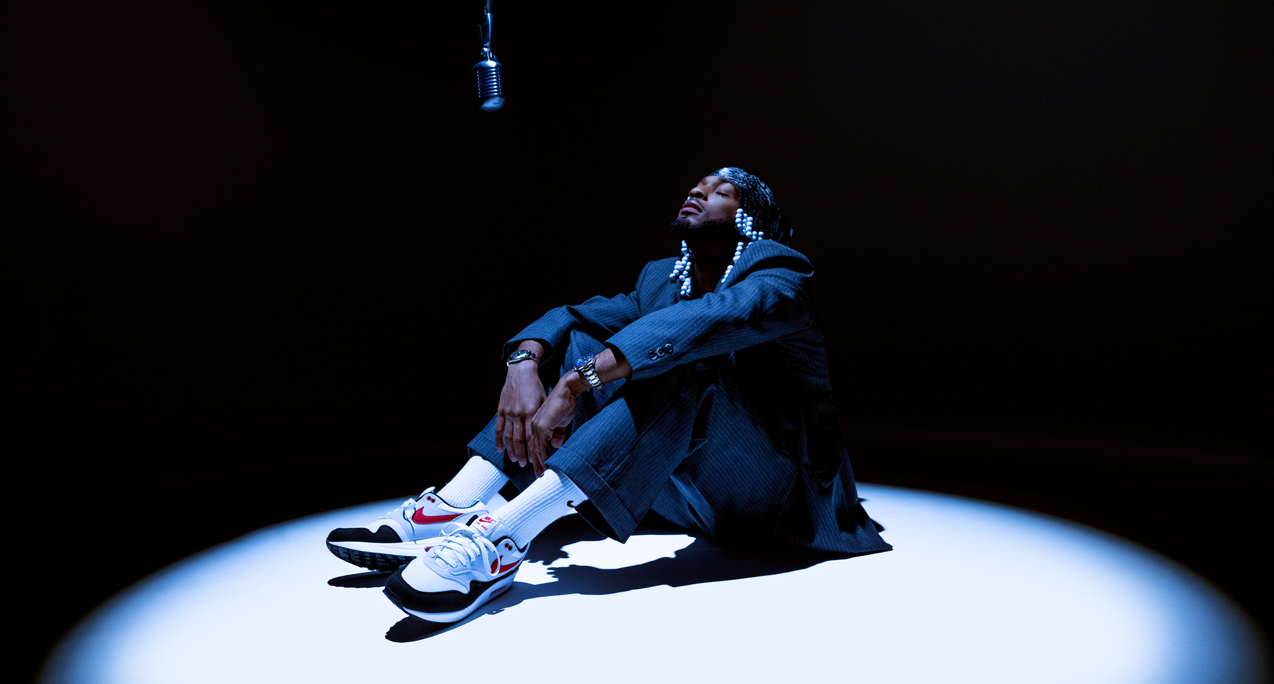 Armani in spotlight with mic hanging above