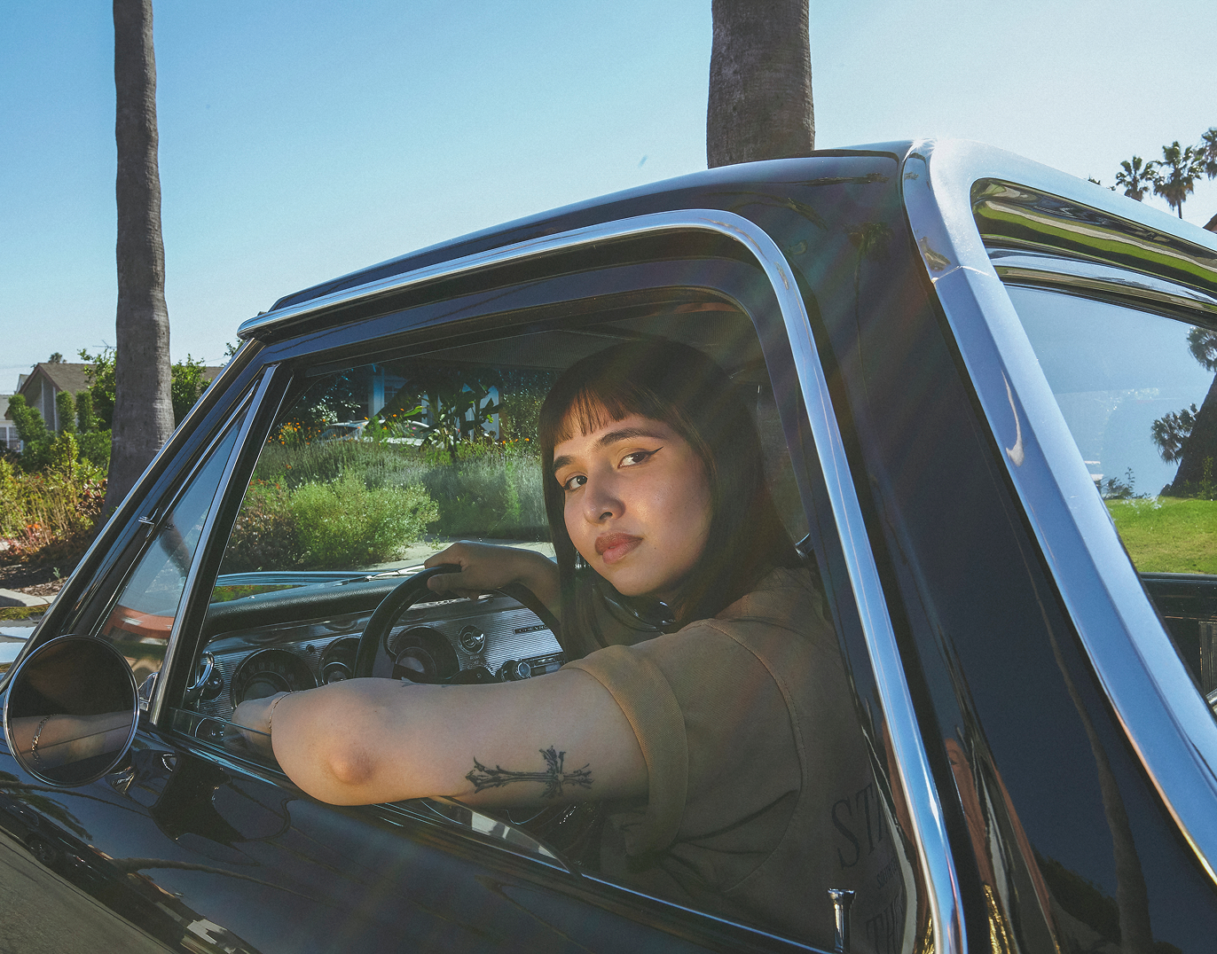 Woman with bangs looking out car window