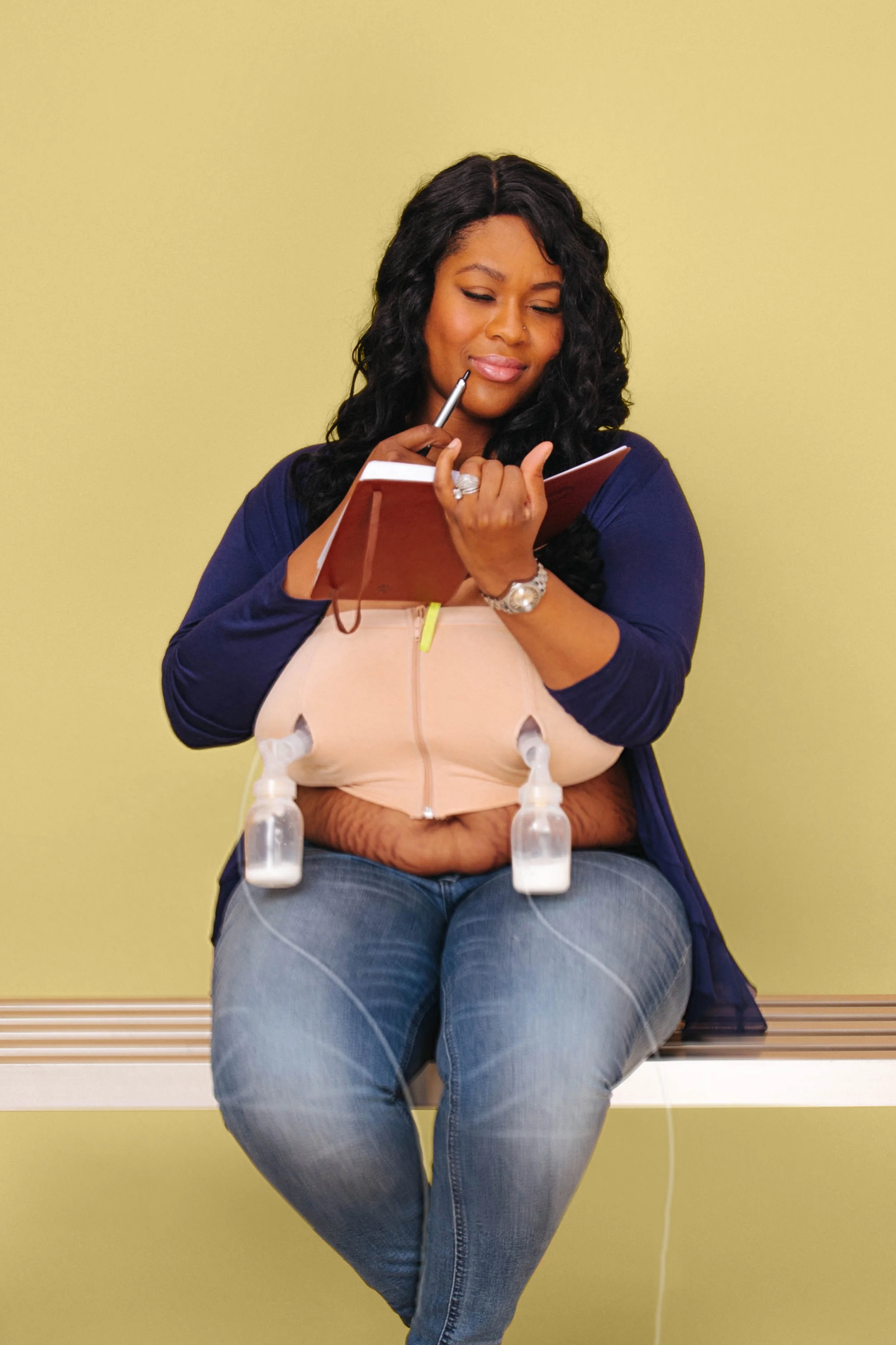 Mom reading with breast pumps