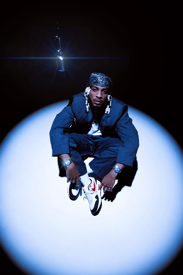 Armani in spotlight with mic hanging above