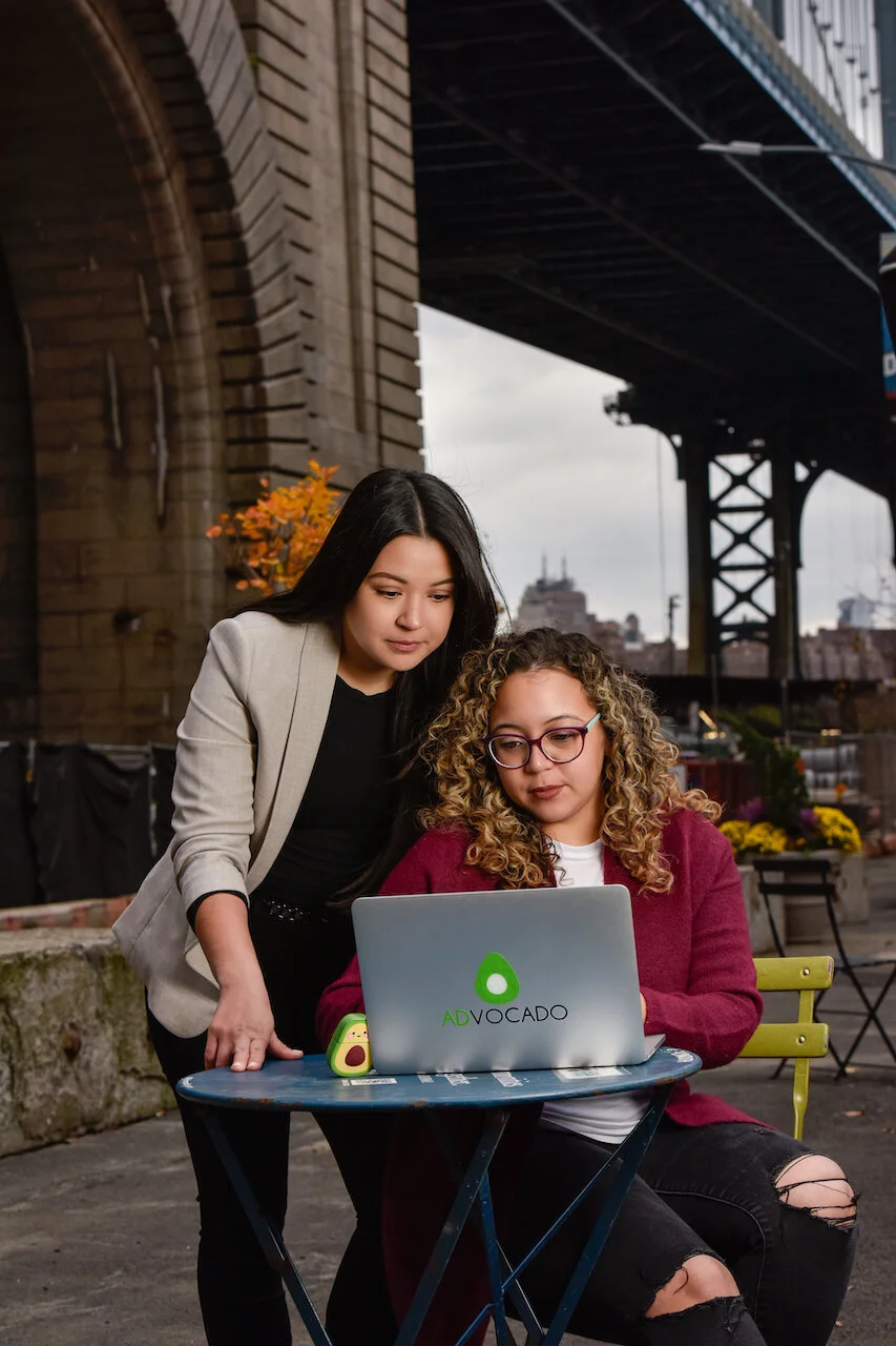 Veronica DeArmas and Katherine Tabares of Advocado Marketing Group collaborating on a marketing project