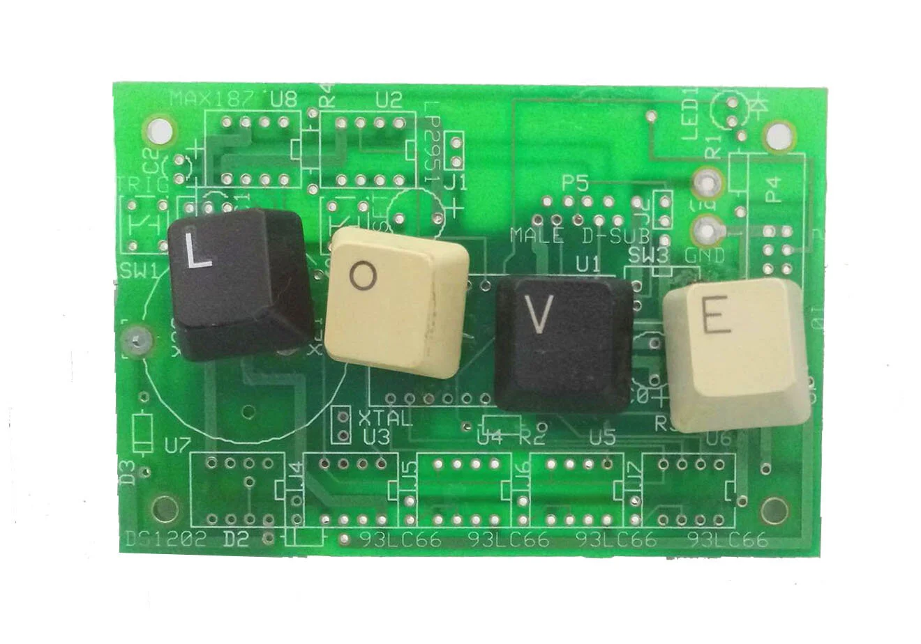 A red circuit board labeled 'MEGA Pro Mini 3.3V' with four keycaps spelling 'SEAN.'