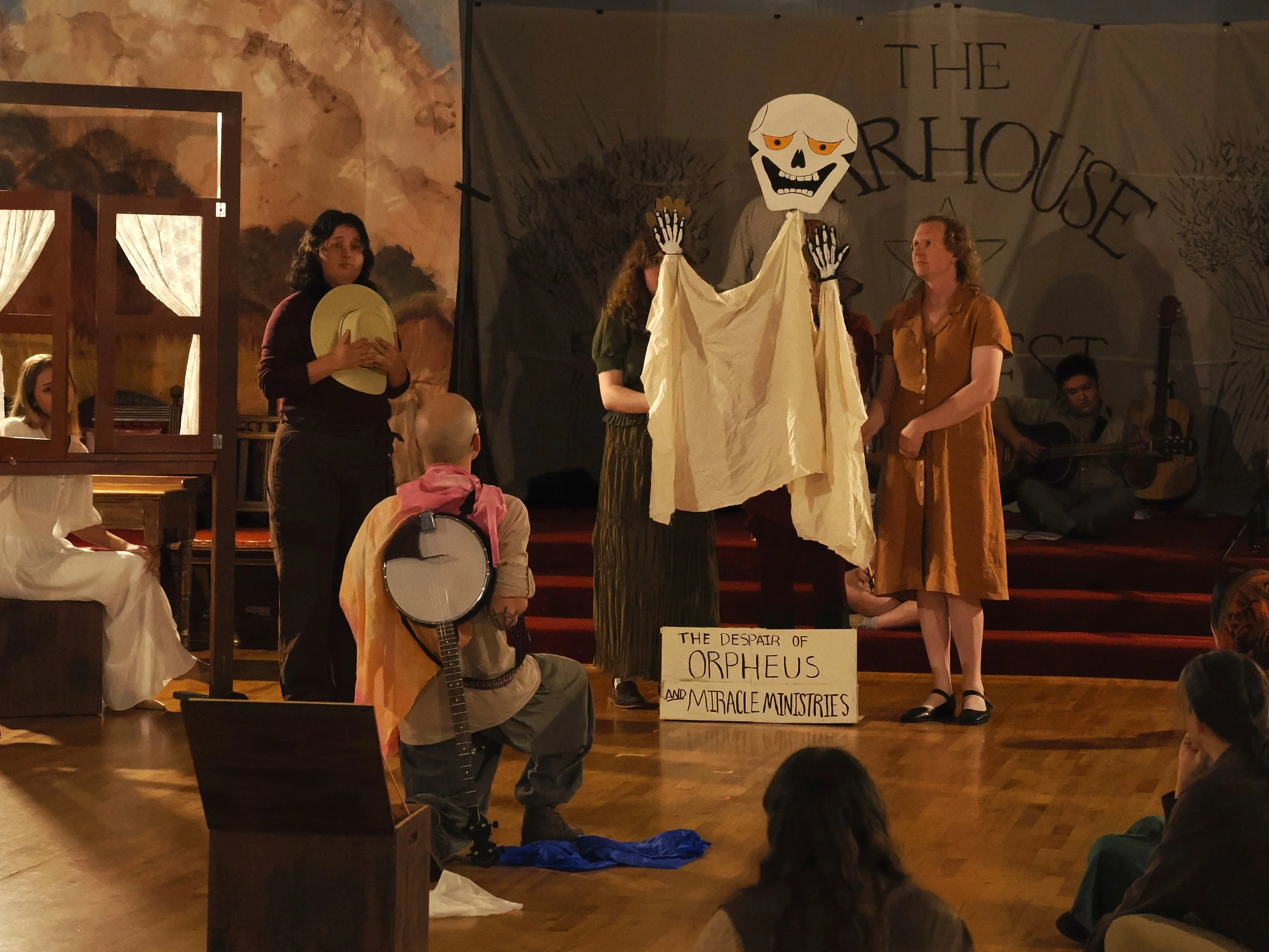 The Carpenter tells the peasants the story of Orpheus and Eurydice, with the help of peasant puppeteers, as Giselle watches from her window