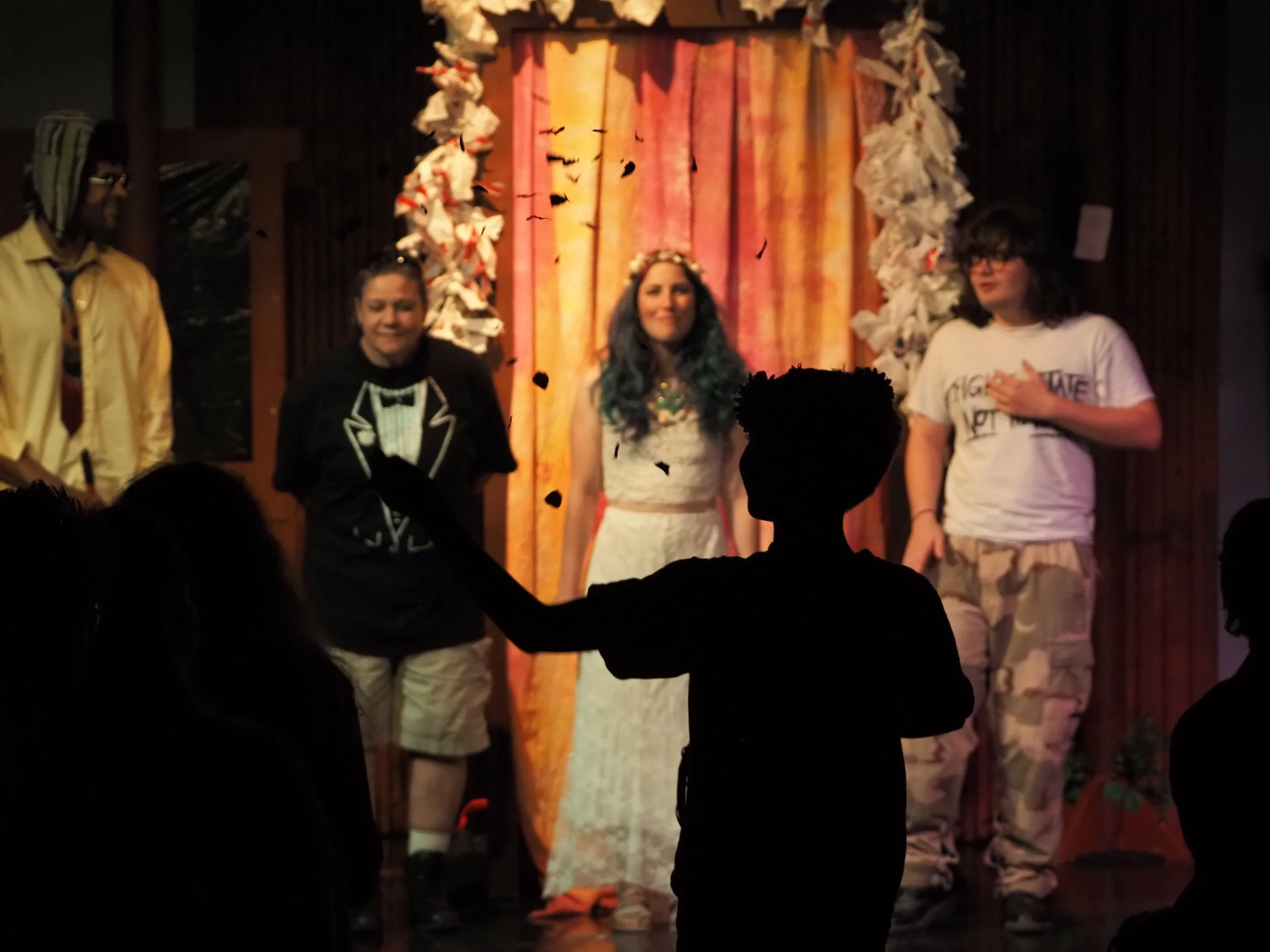 A flower child (Neil Birkle) processes up the aisle as the wedding party look on (left to right: Christopher Rozier, Karol-Ann Coleman, Evie Bennett, Francisco "Frankie" Vargas).