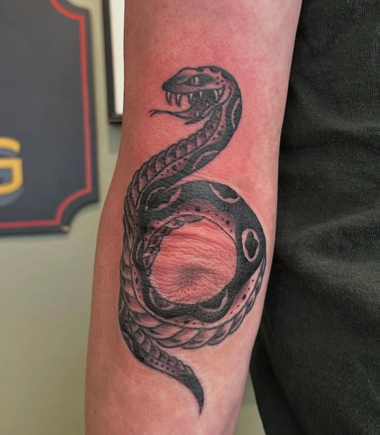 Black and grey snake on the elbow done by @sarahhalltattoos 
To schedule appointments with Sarah head over to her page and send her and email.