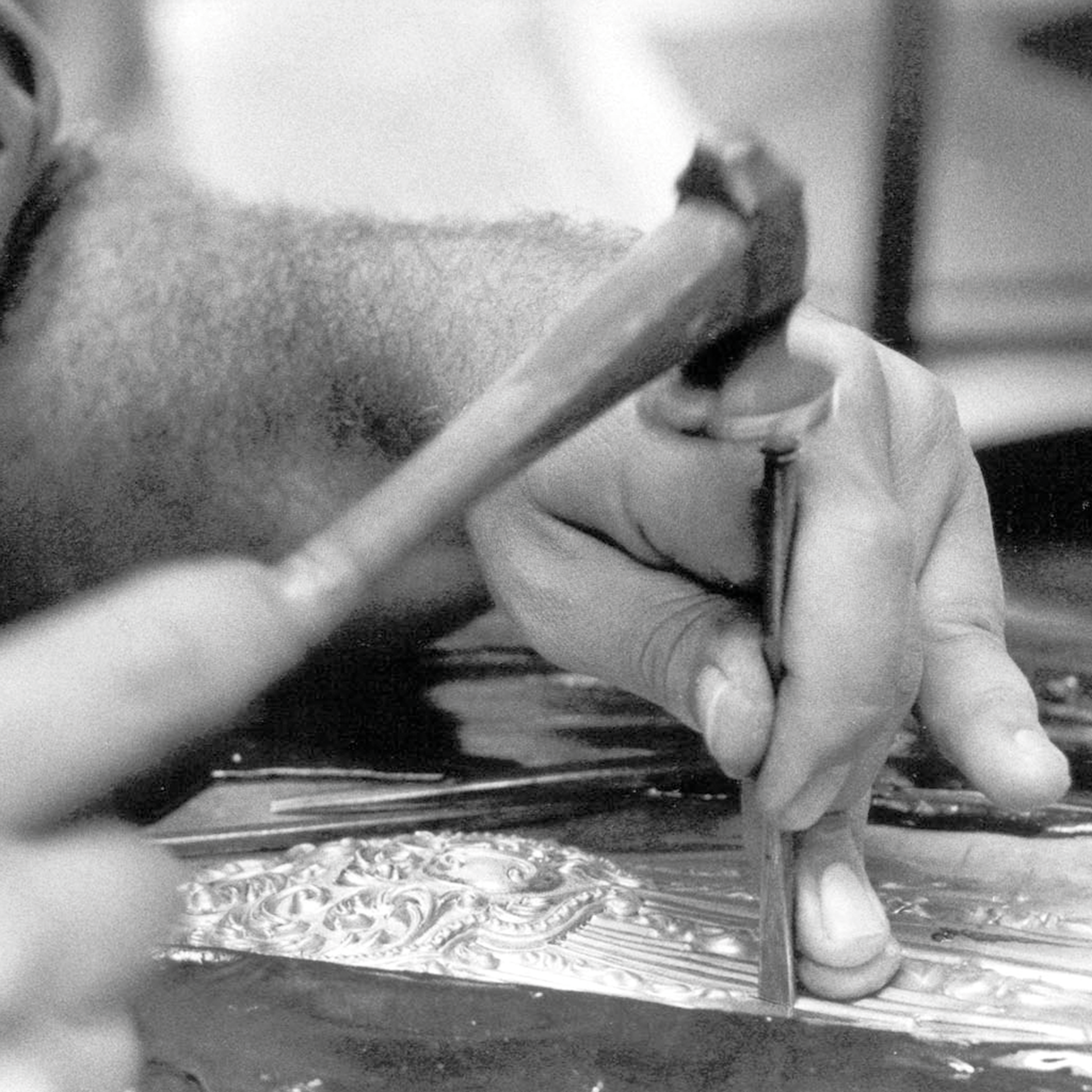 ENGRAVING -  Engraving involves cutting fine lines or motifs directly into the metal surface using sharp burins. It allows for precise ornamental detail or subtle inscriptions, revealing contrasts between polished and matte areas.This technique deman