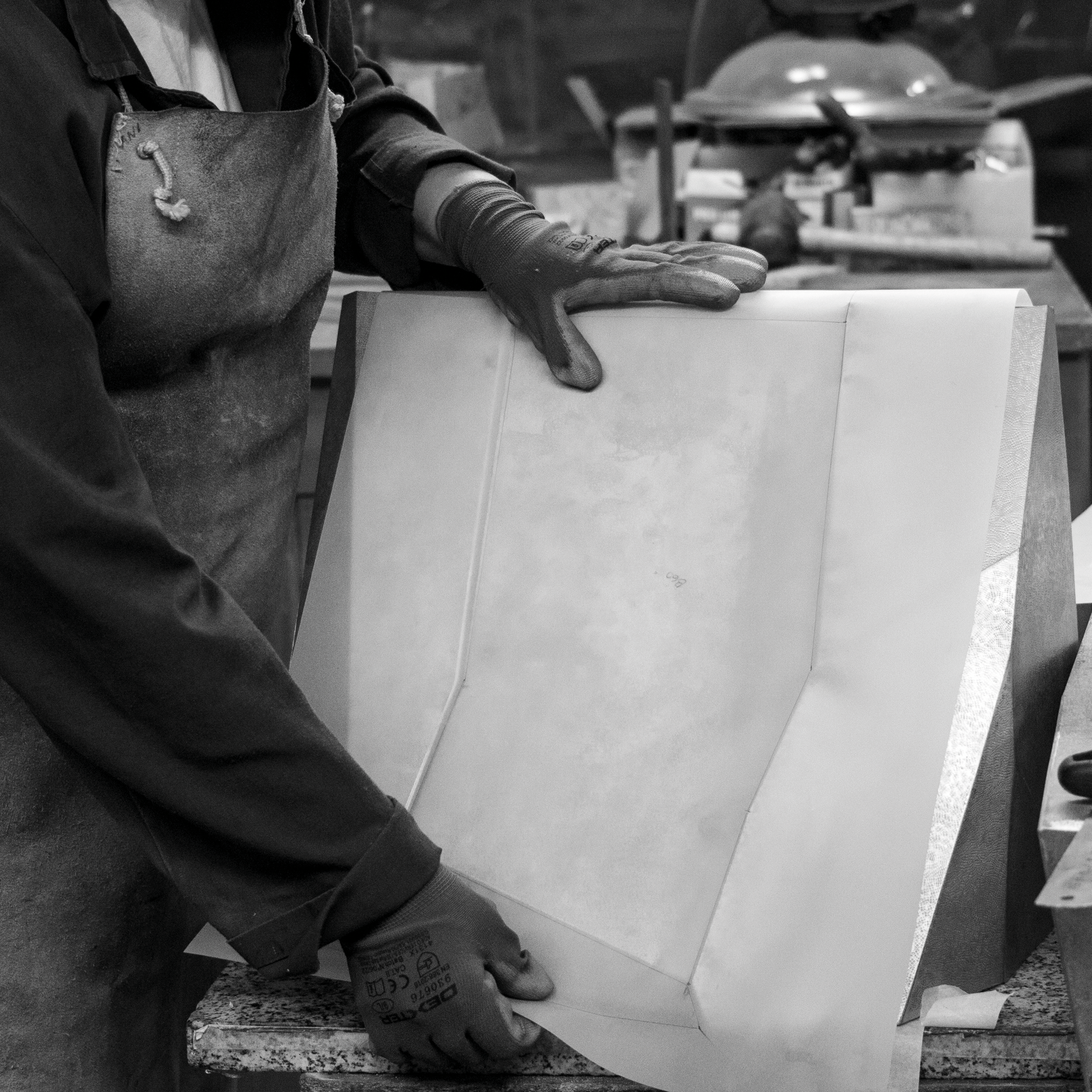 COLD BENDING - Used for designs defined by straight lines and sharp angles, cold bending involves scoring and folding the metal sheet along precisely marked edges. Employing a fine triangular-ended punch and a set square, the craftsman bends the mate